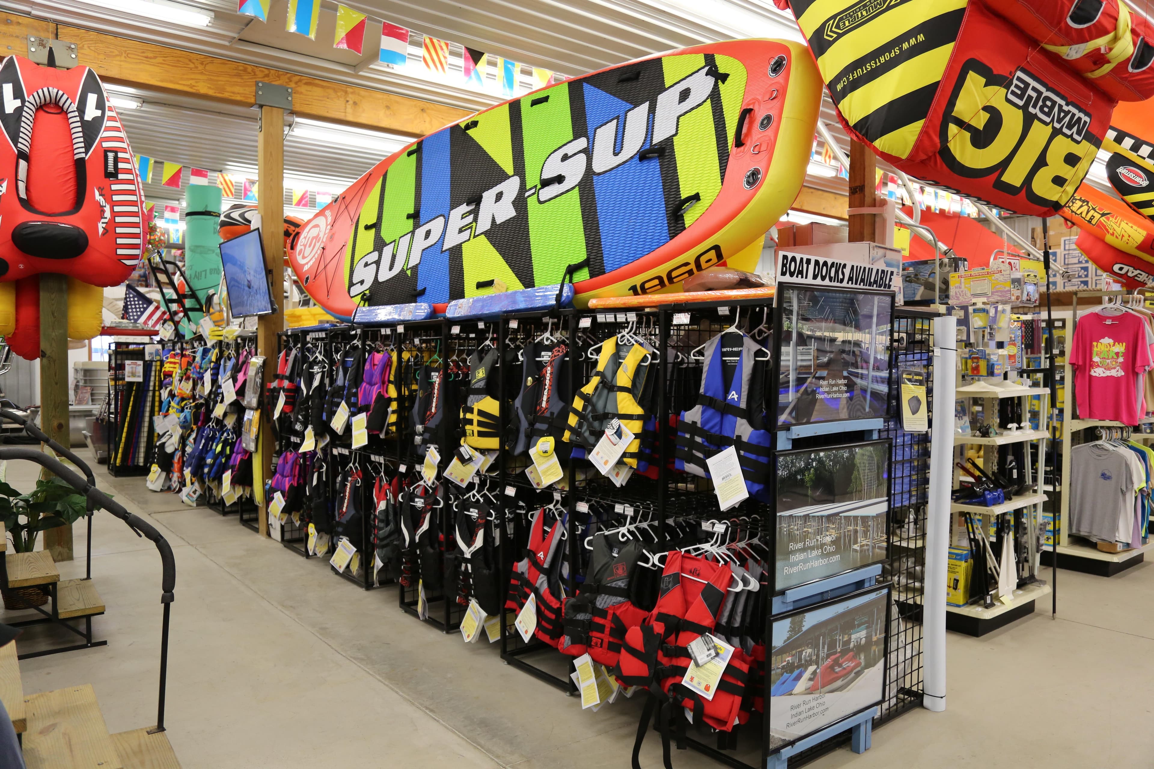 Water sports store with colorful life jackets and inflatable boards, Sylvan Mirage 8520 CLZ DH 2026.