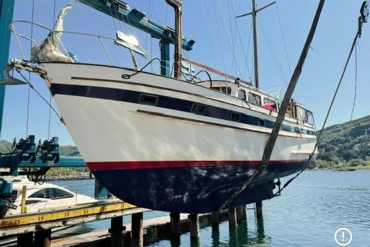 1980 Island Trader 46 sailboat suspended over water at a marina.