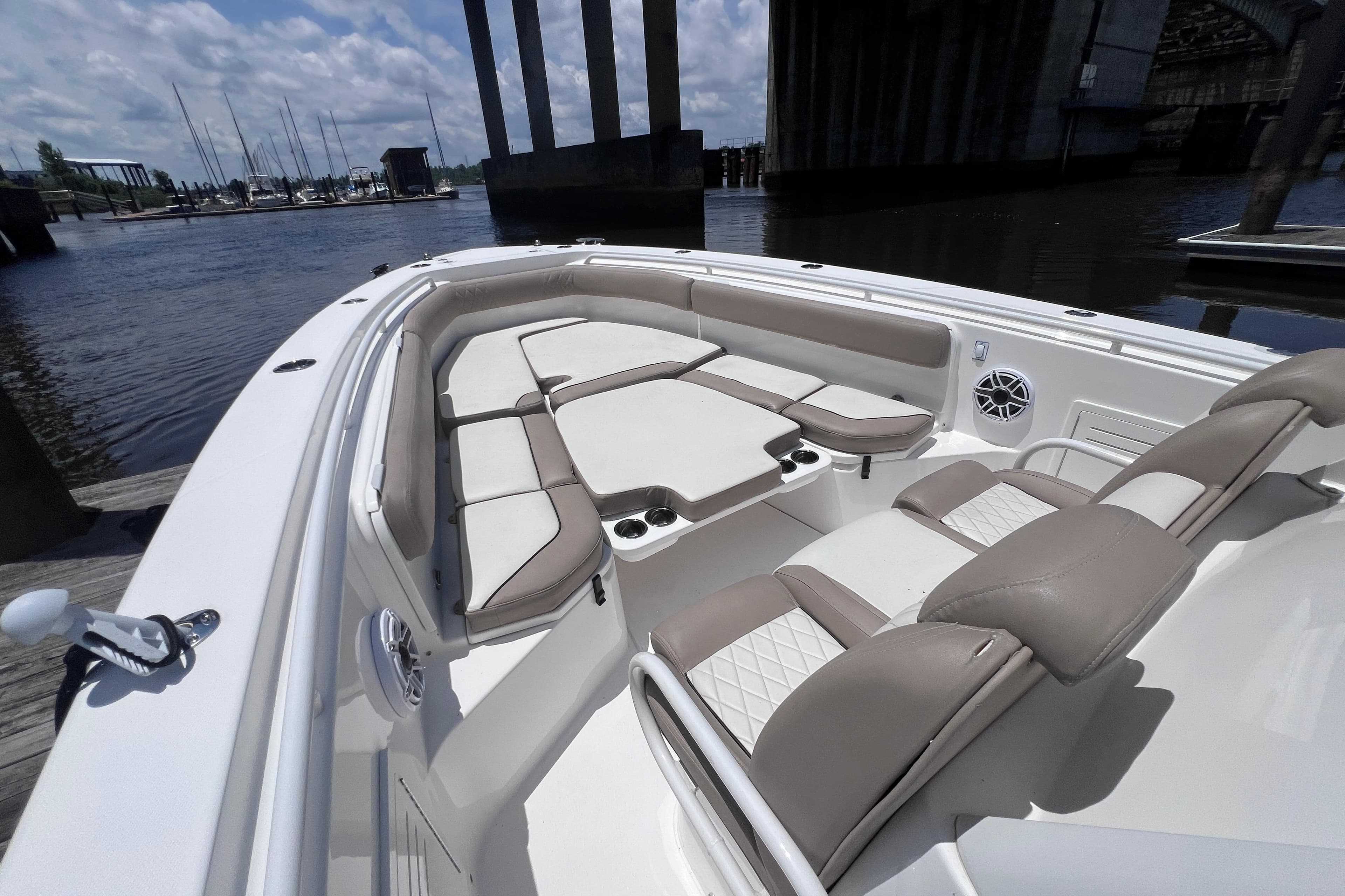 2020 Everglades 365 Center Console boat interior with cushioned seating and cup holders.