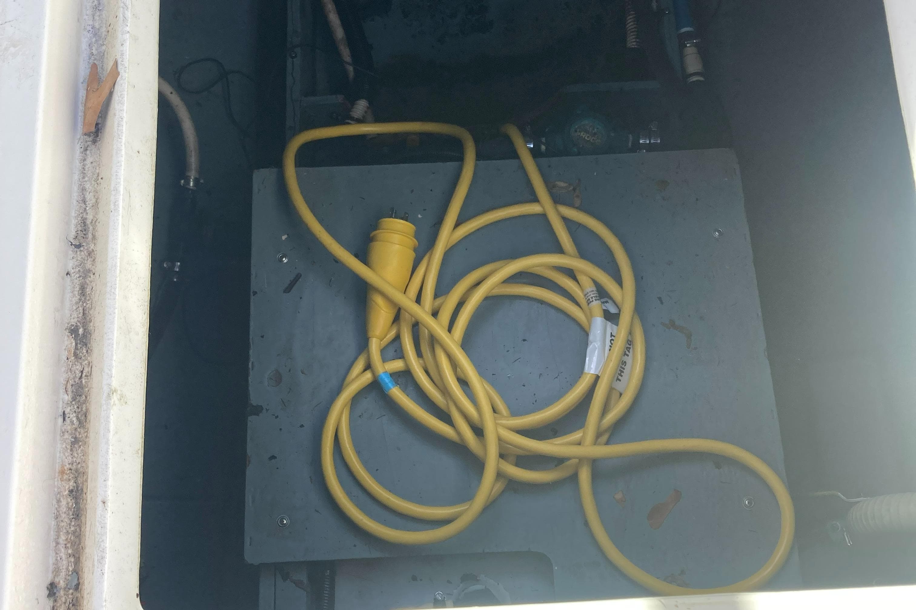 Yellow power cable in a 1992 Sea Ray 300 Weekender boat compartment.