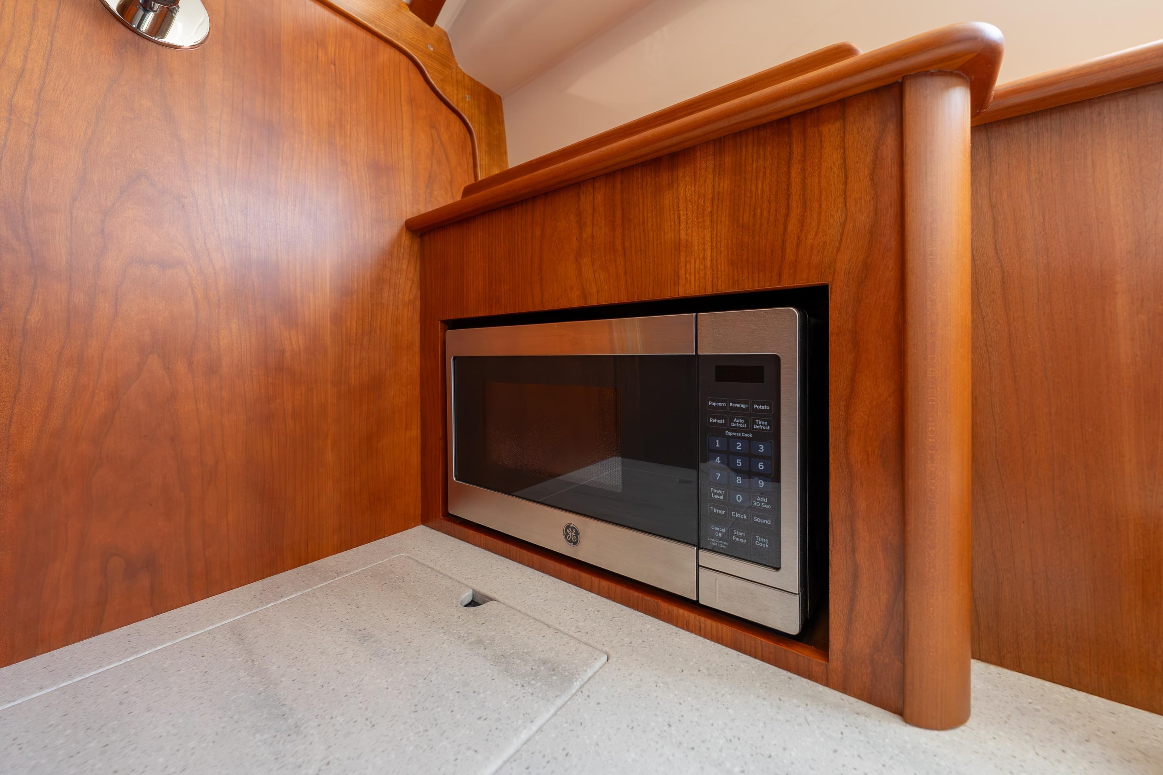 Built-in microwave in 2024 Hinckley 35 yacht's wooden interior kitchen.
