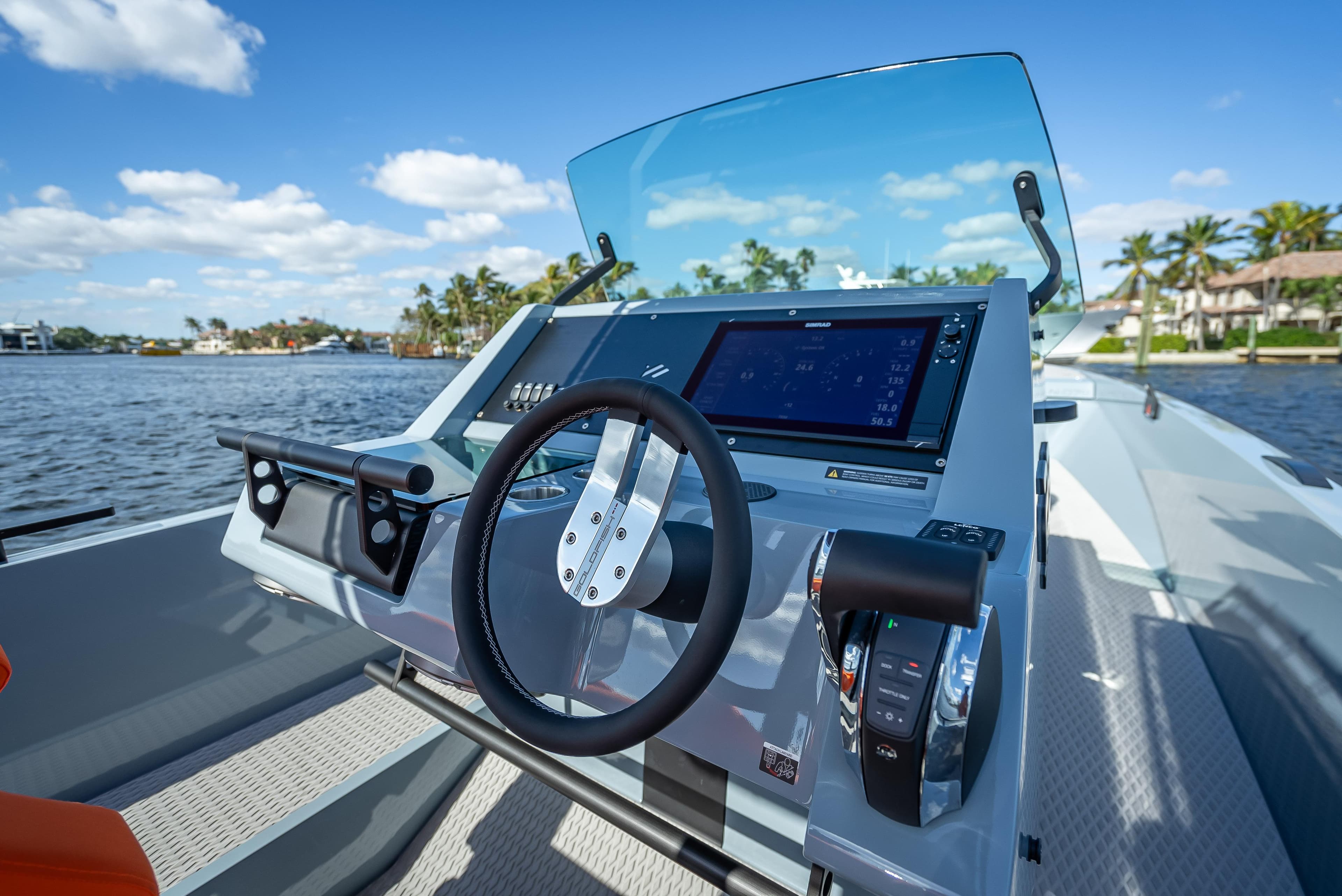 2024 Goldfish 28 Tender boat dashboard with steering wheel and navigation system.