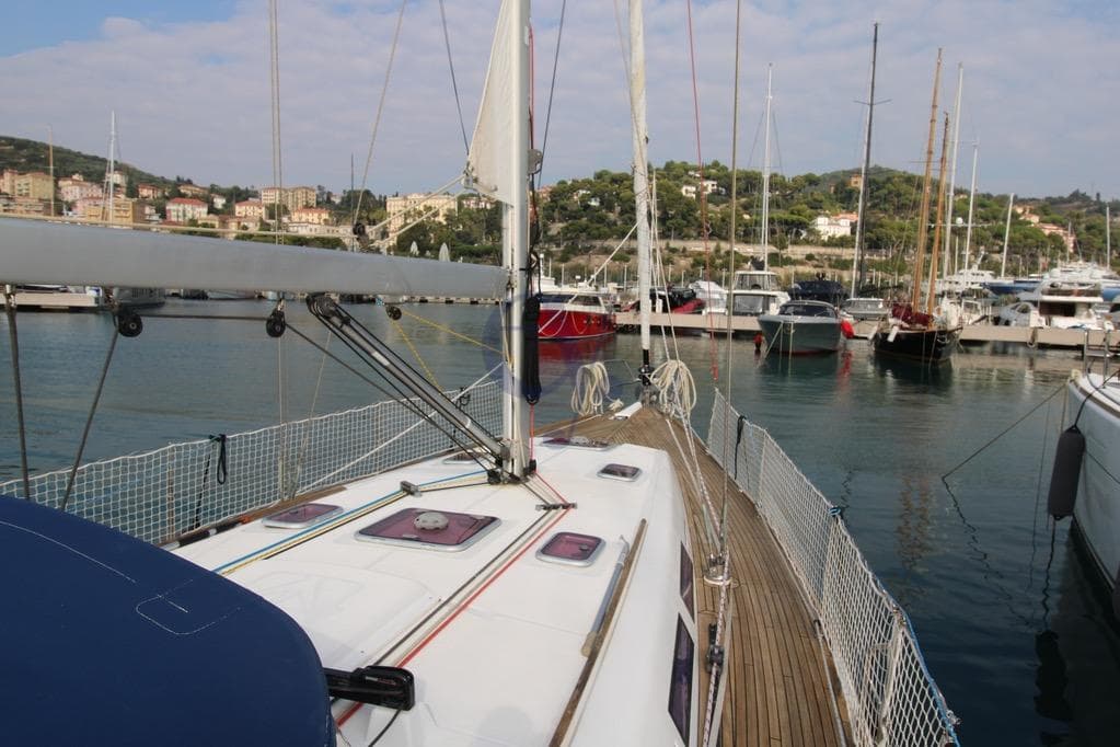 2009 Dufour 425 Grand Large sailboat docked in a scenic marina.