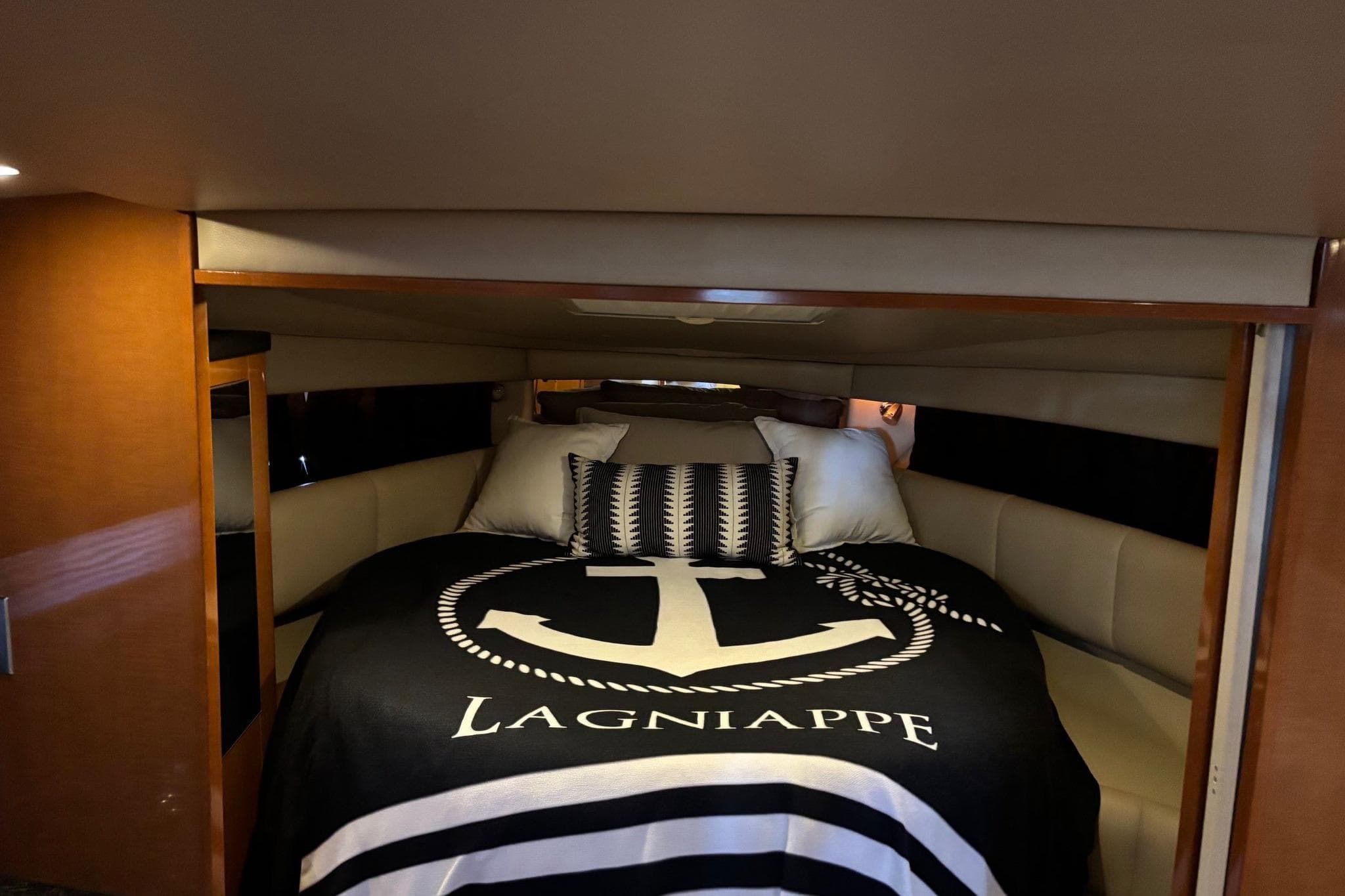 Luxurious cabin interior of 2010 Chaparral Signature 370 yacht with cozy bedding.