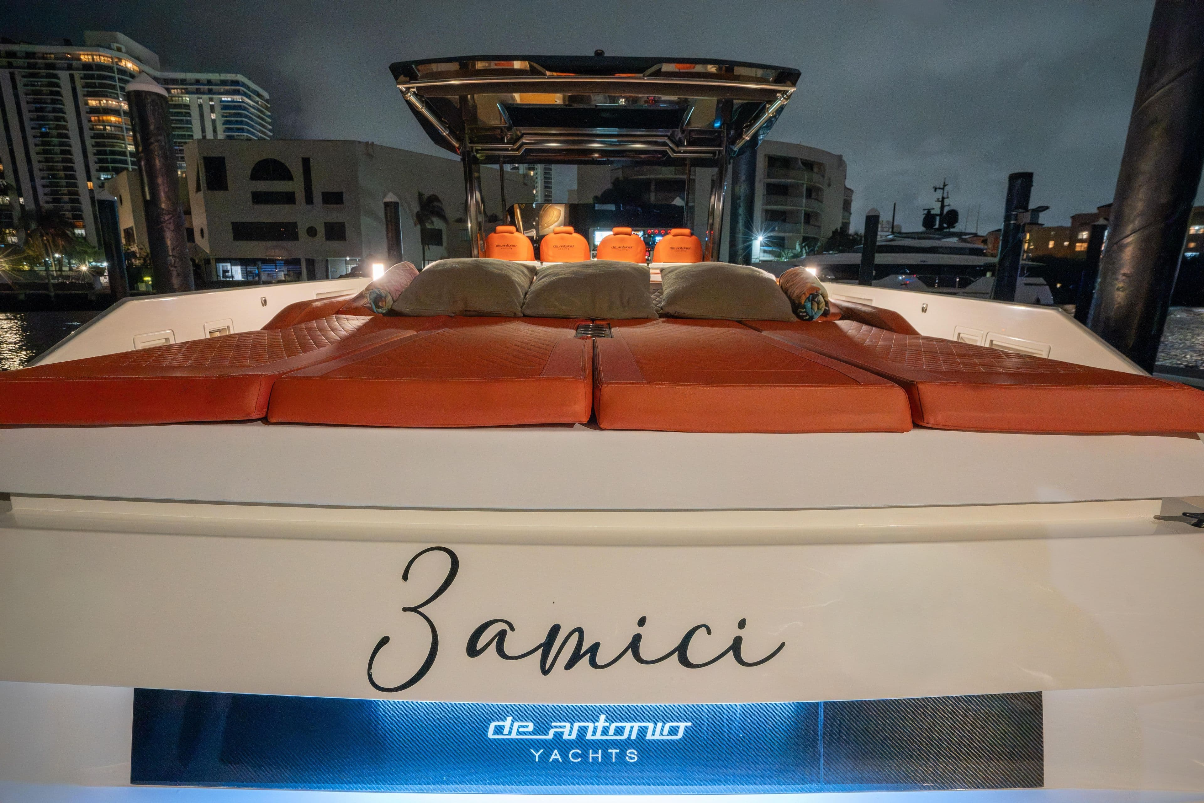 2023 De Antonio Yachts D42 Open with luxurious deck and cityscape backdrop.