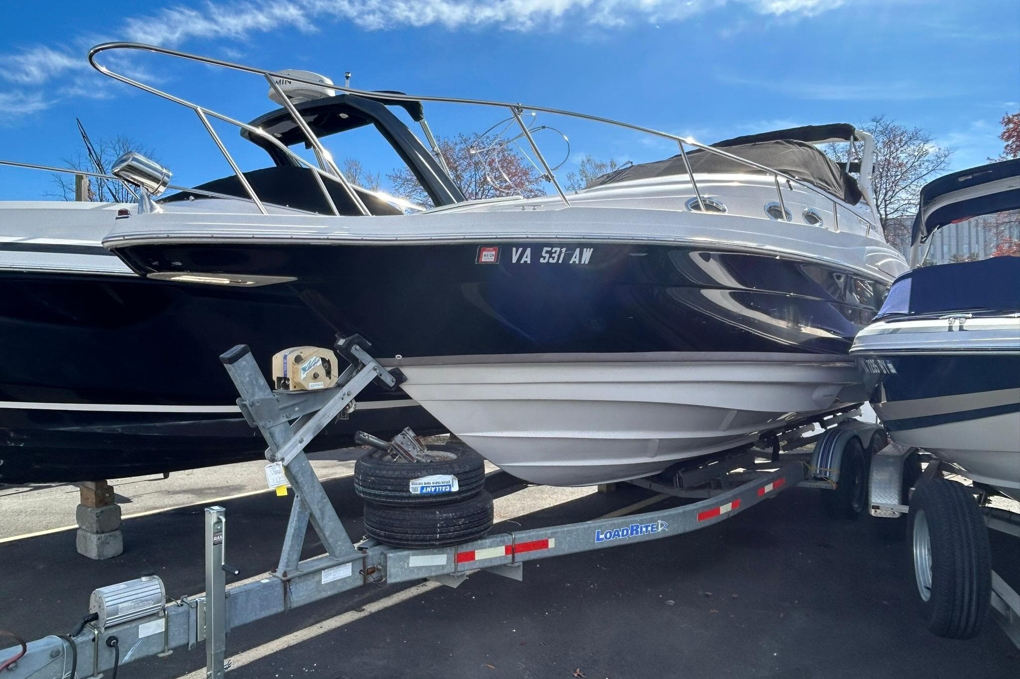 2004 Regal Commodore 2860 boat on trailer under clear blue sky.