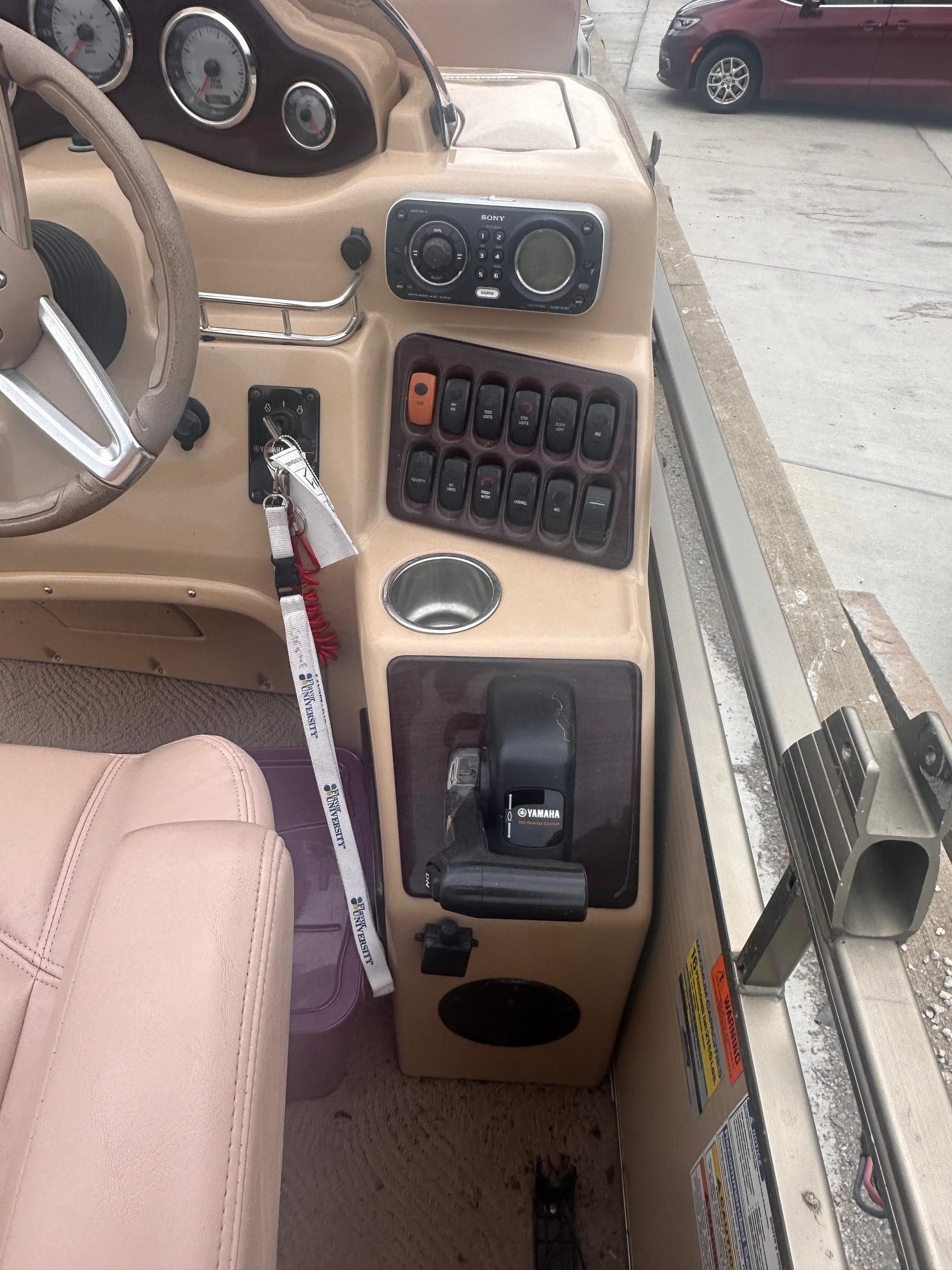 2008 Godfrey Sanpan 2500 RE boat dashboard with controls and Yamaha throttle.