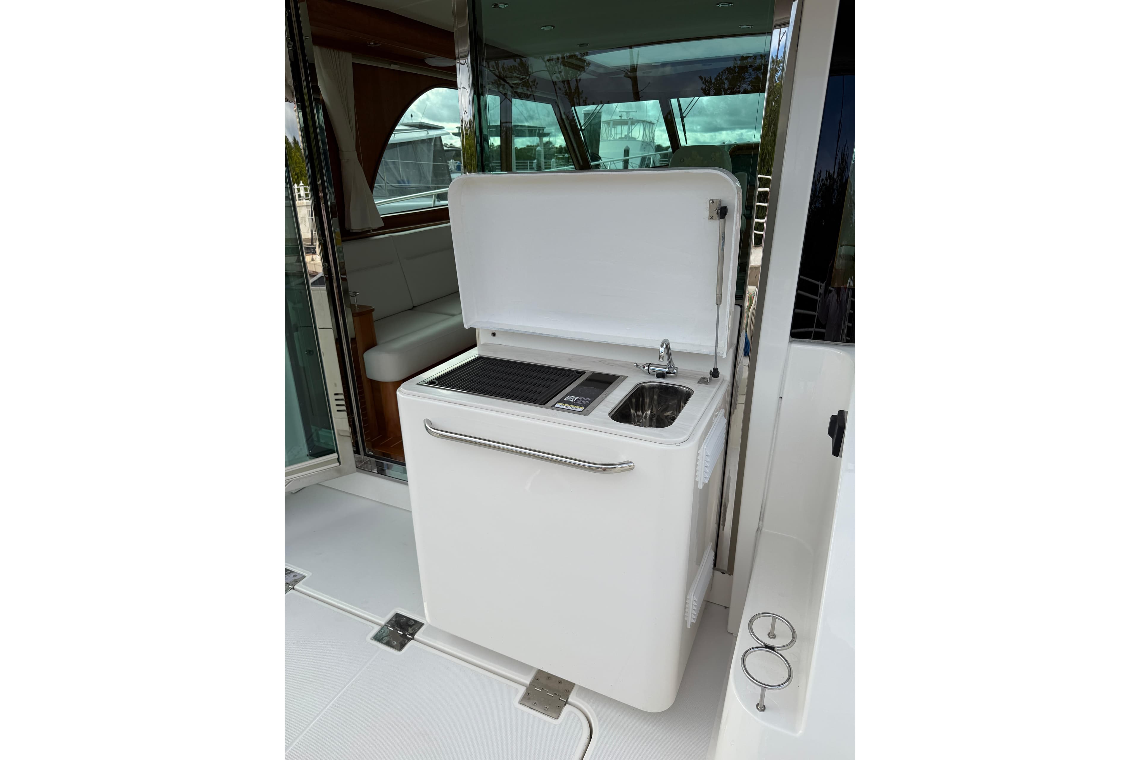 Outdoor kitchenette on 2026 Sabre 45 Salon Express yacht with sink and grill.