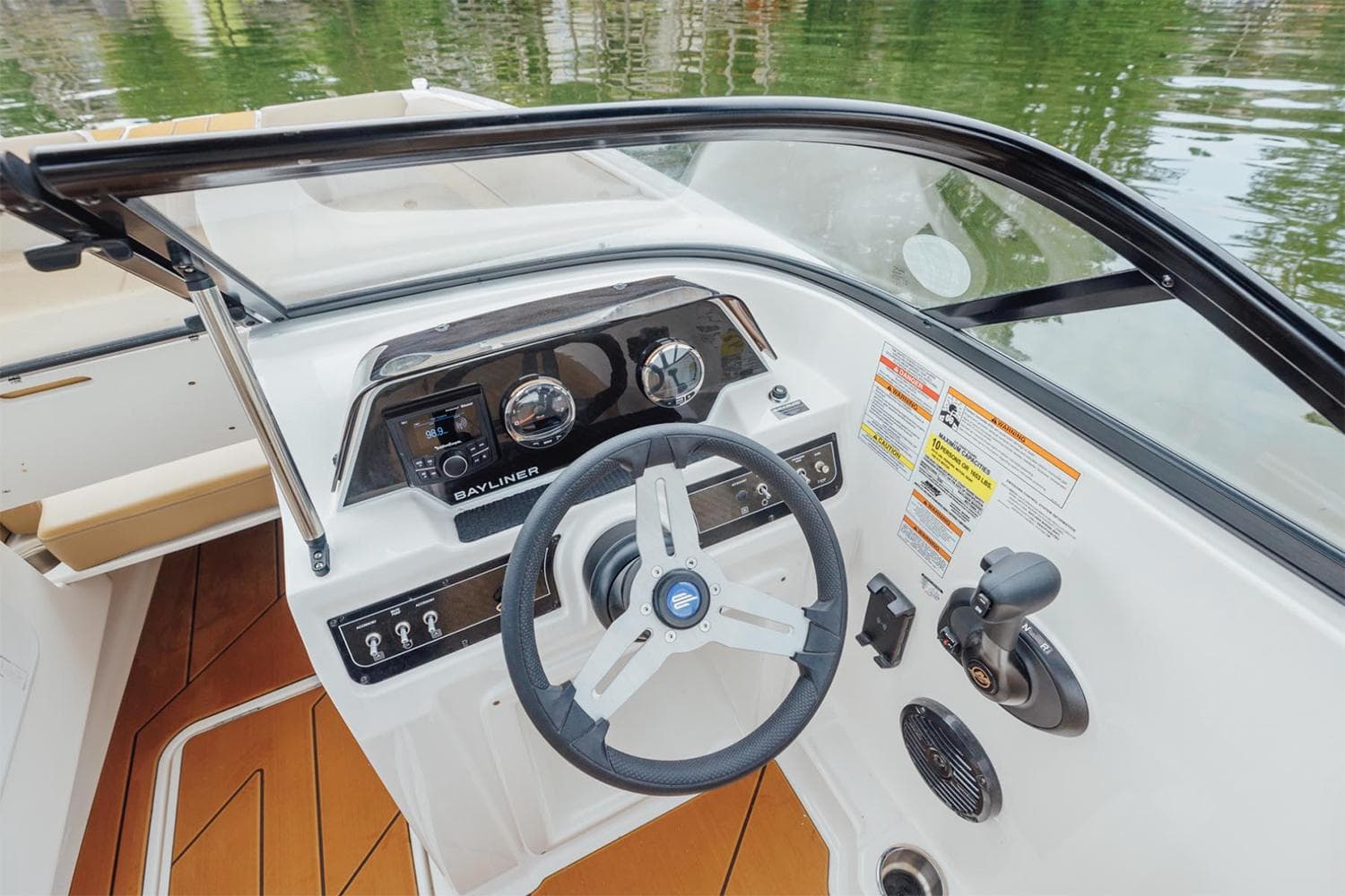 Manufacturer Provided Image: 2025 Bayliner D20 boat dashboard with steering wheel and control panel on water.