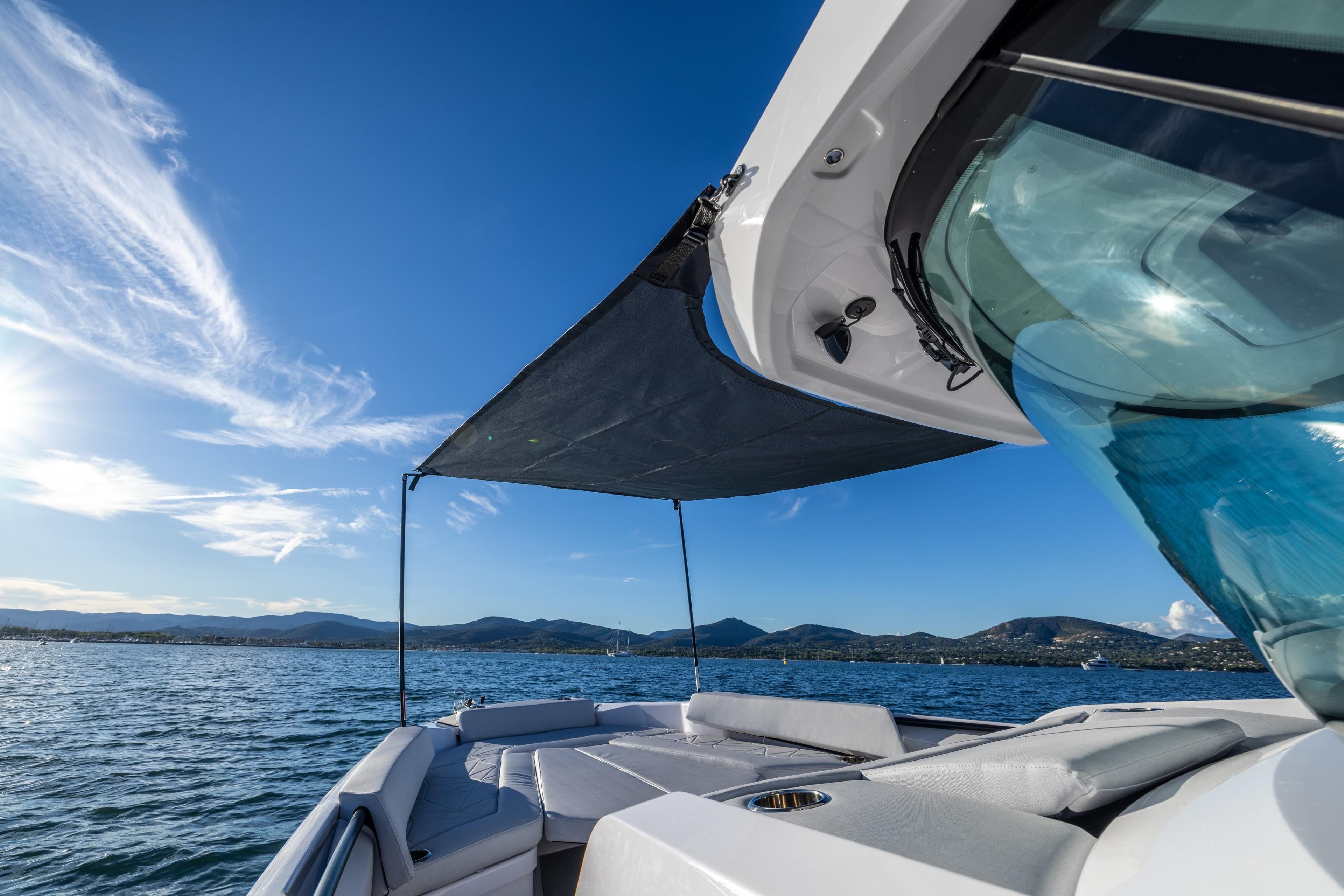 2026 Axopar 29 CCX boat on water, sunny day, scenic mountain view.