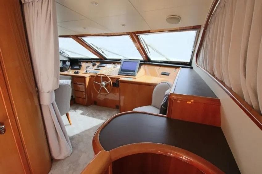 Luxurious interior of 1999 Falcon 86 yacht with modern navigation equipment.