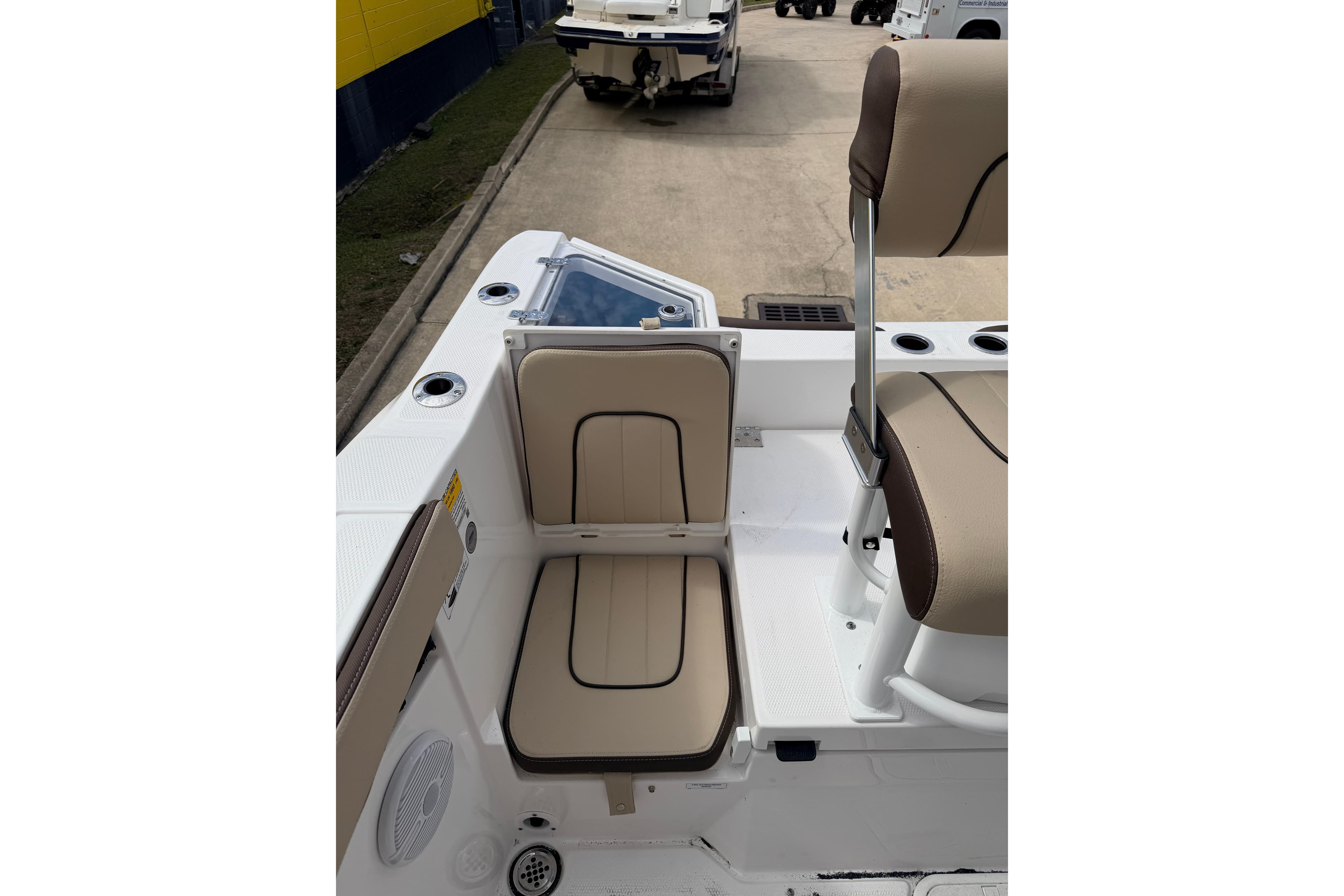 2026 Yamaha Boats 222 FSH Sport interior seating with beige cushions and cup holders.