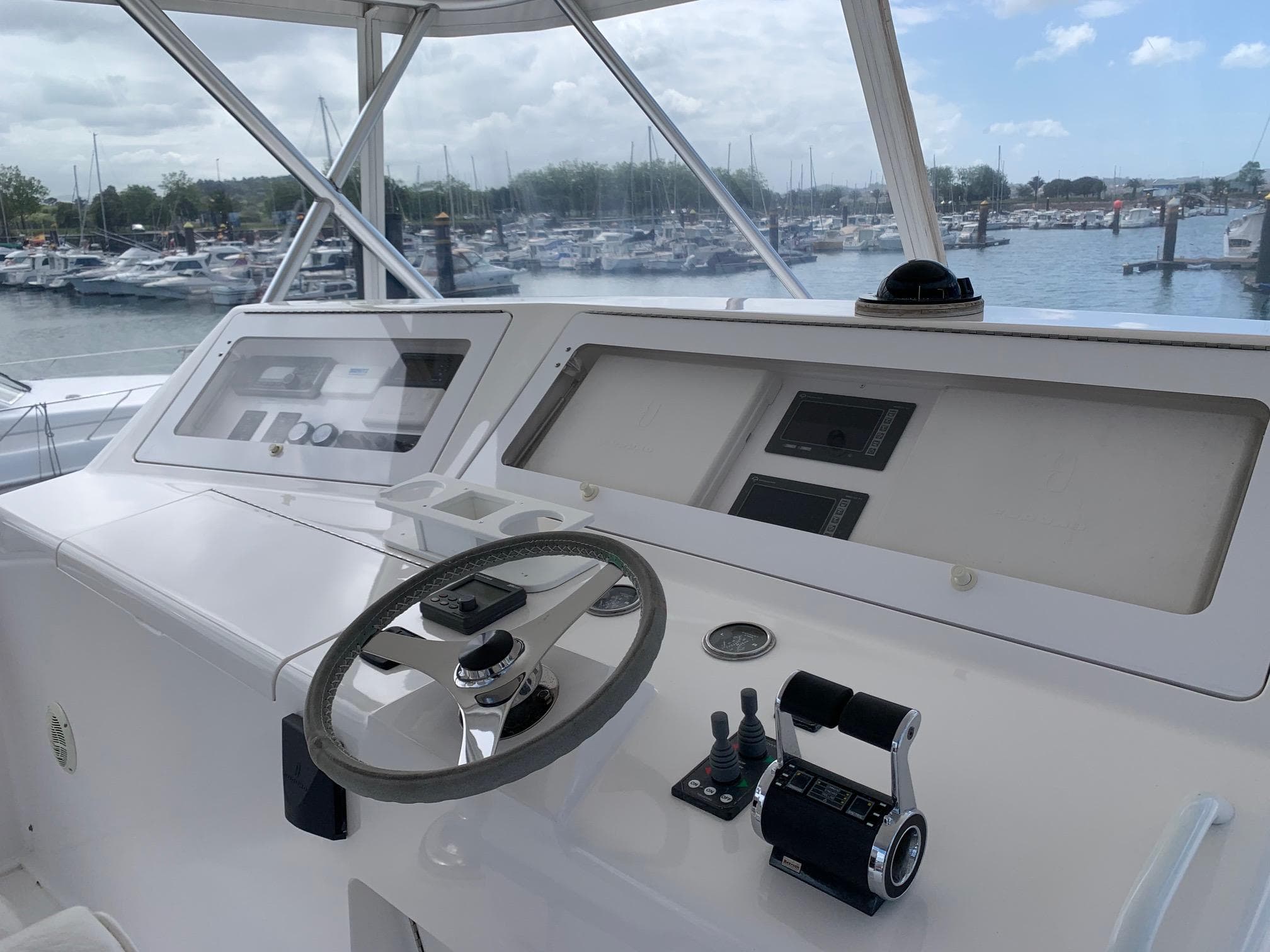 Helm of 2007 Viking 52 yacht with marina view in background.