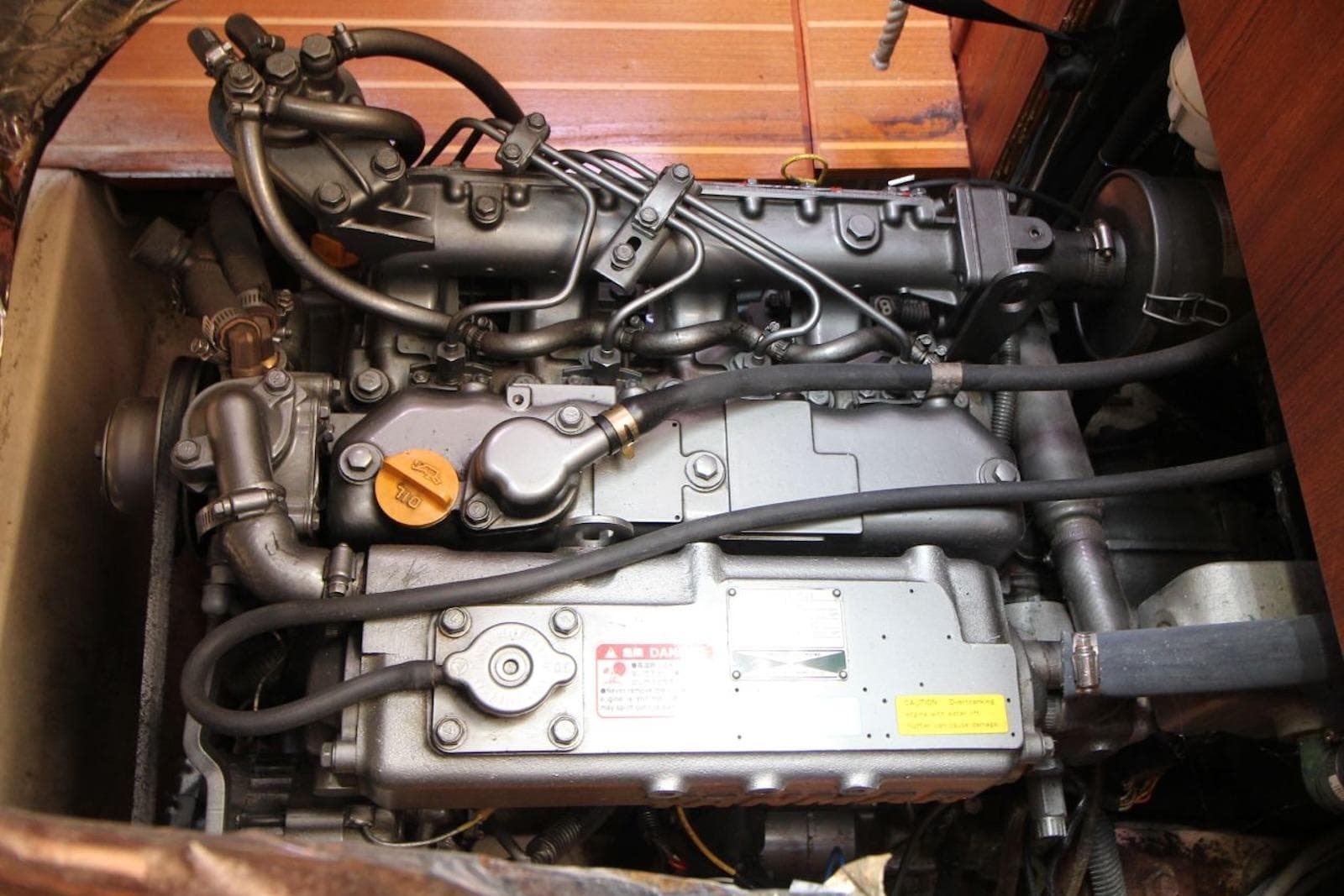 Engine of a 2000 Hunter 410 sailboat, showcasing intricate mechanical components.