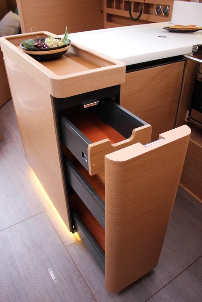 Modern kitchen drawer in 2025 Jeanneau Sun Odyssey 440 yacht, featuring sleek wood design.