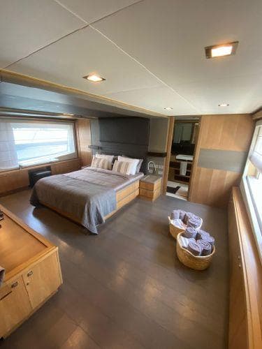 Luxurious bedroom in 2011 Ferretti Yachts Custom Line 100, featuring modern design and ample natural light.