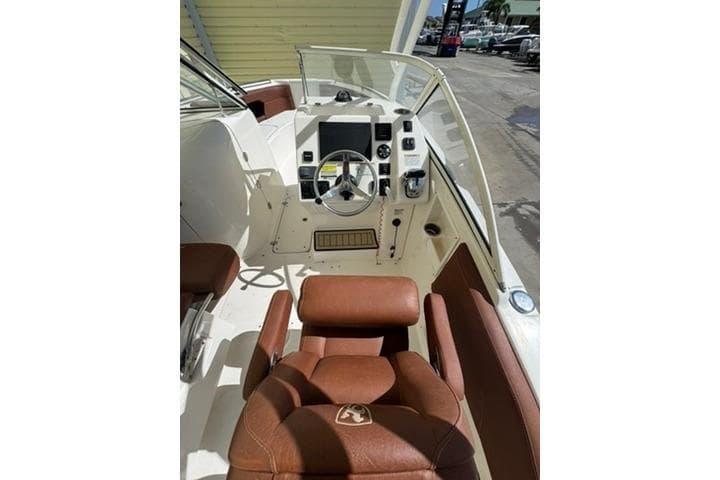 2019 Century 24 Resorter boat interior with brown leather seating and modern dashboard controls.