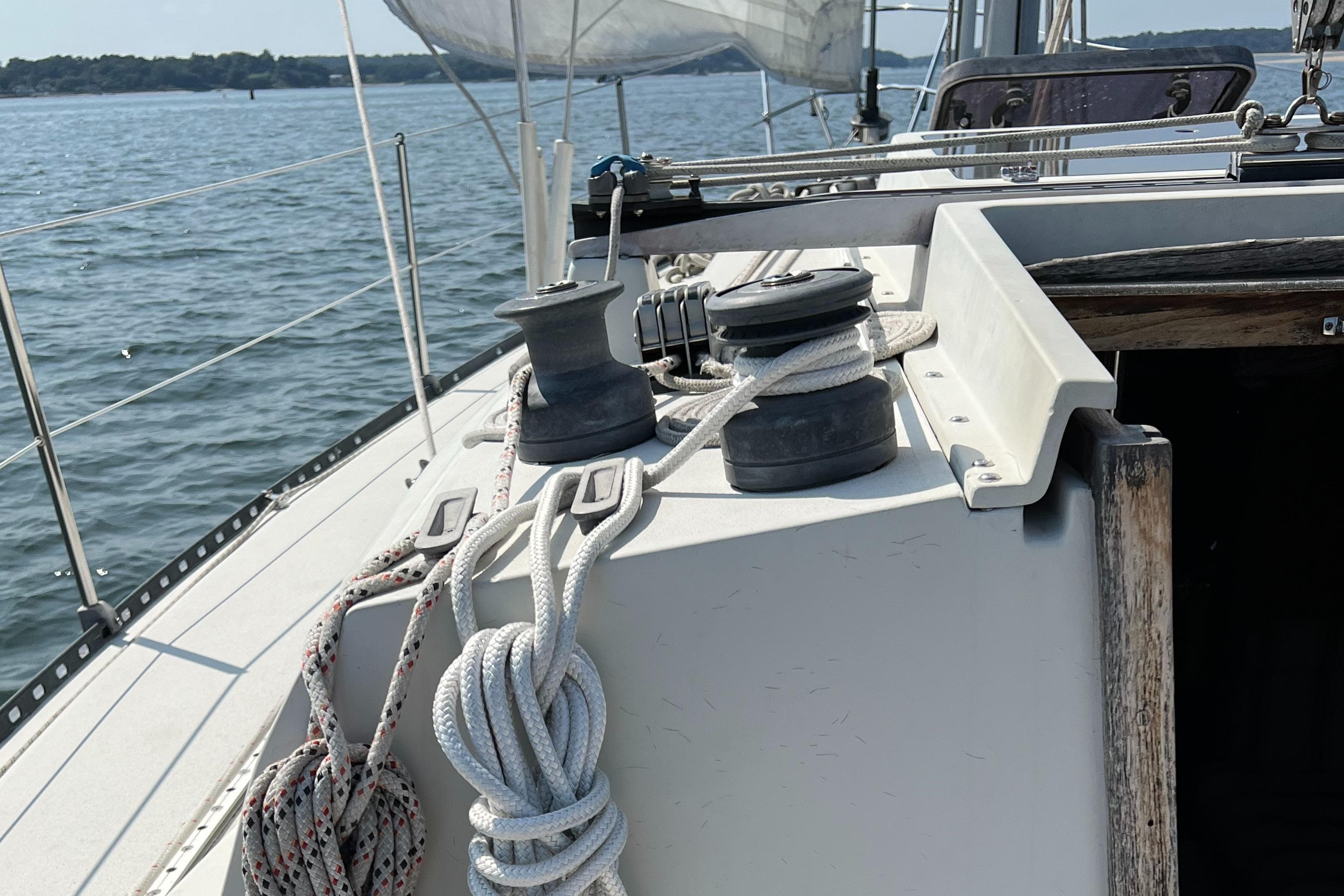 1983 C&C 35 MKIII sailboat deck with winches and ropes on a sunny day.