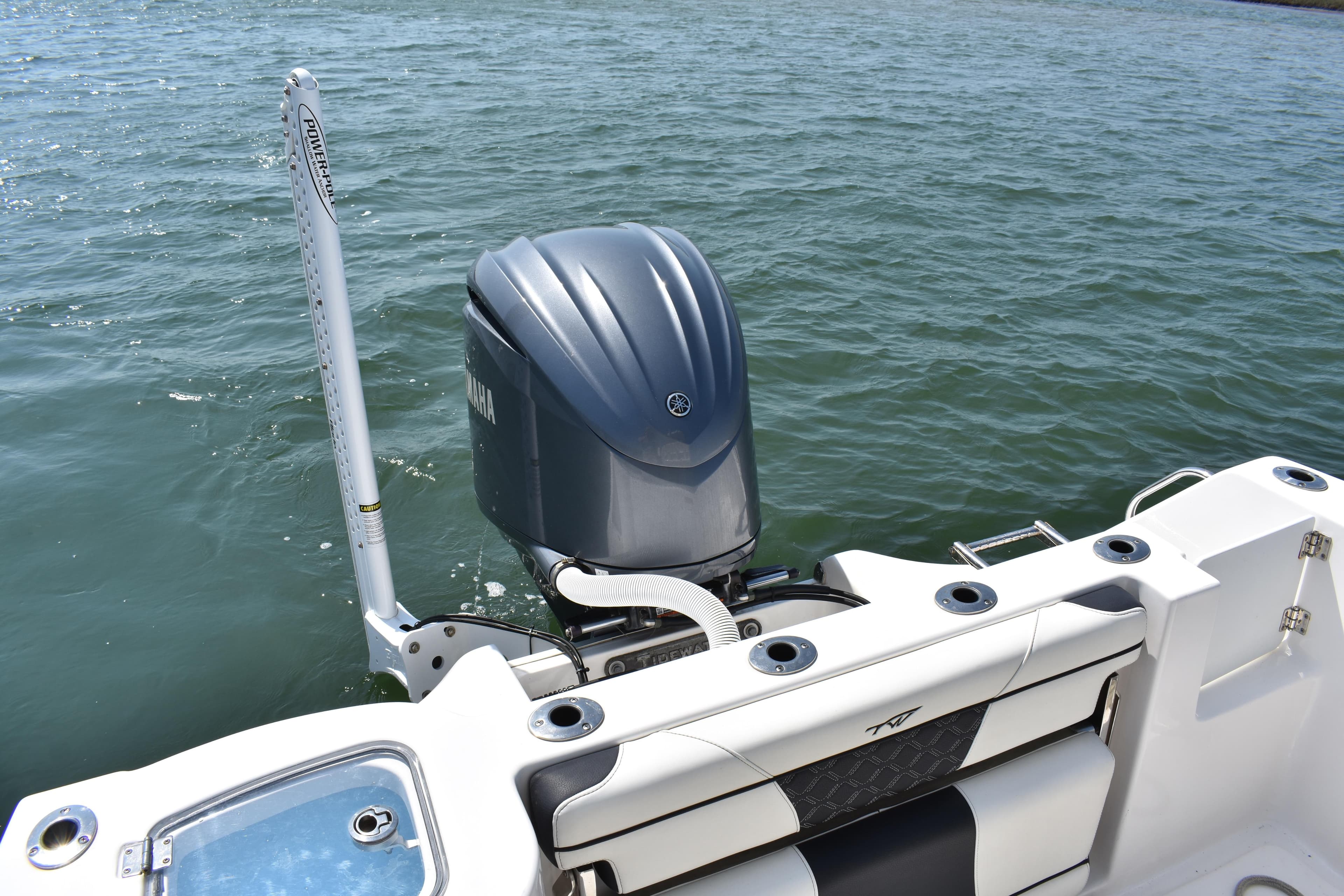 2023 Tidewater 232 CC Adventure boat with Yamaha outboard motor on water.