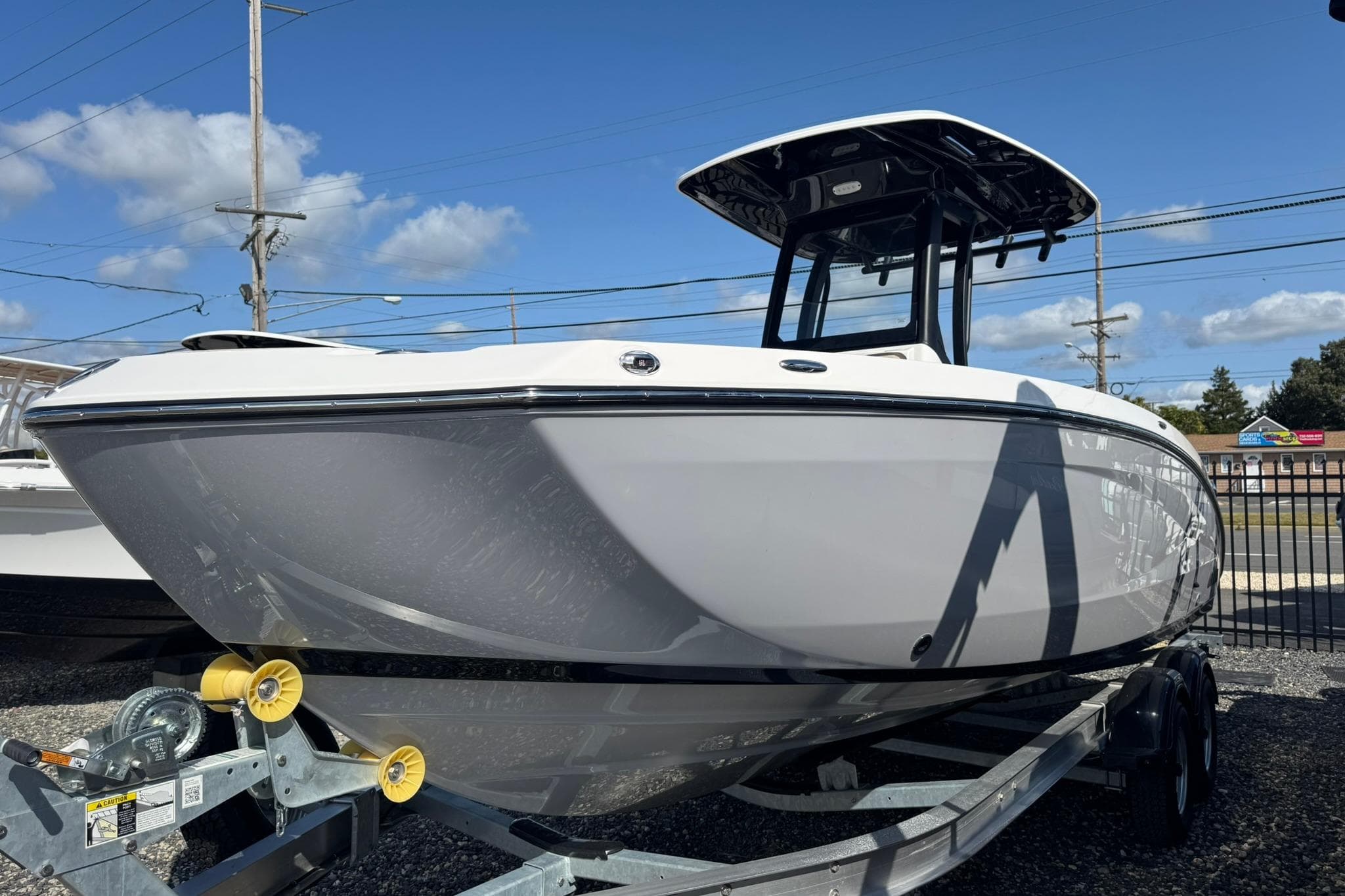 2026 Yamaha Boats 255 FSH Sport H on trailer under clear blue sky.