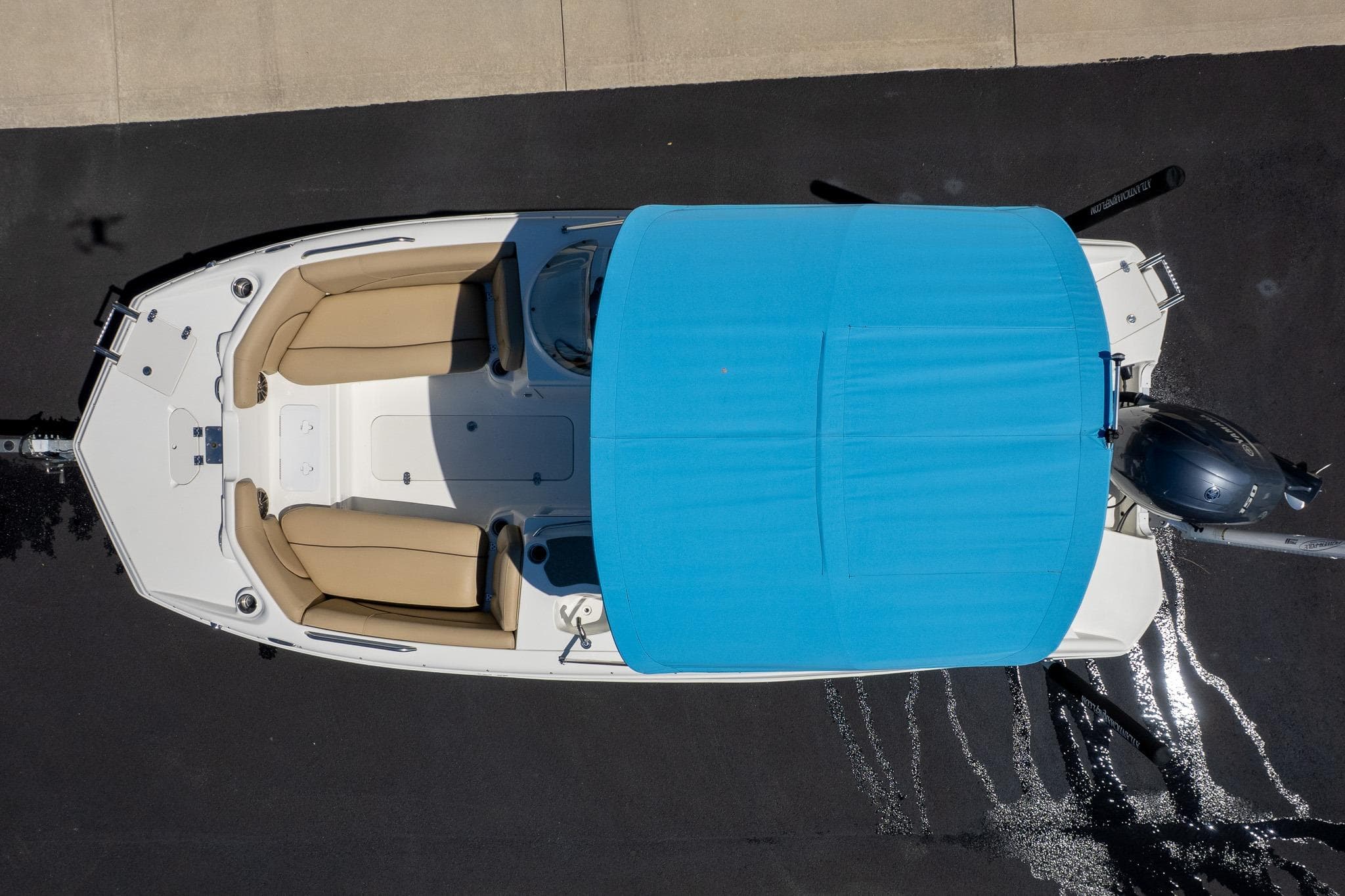Aerial view of 2020 NauticStar 203 SC boat with blue canopy and beige seating.