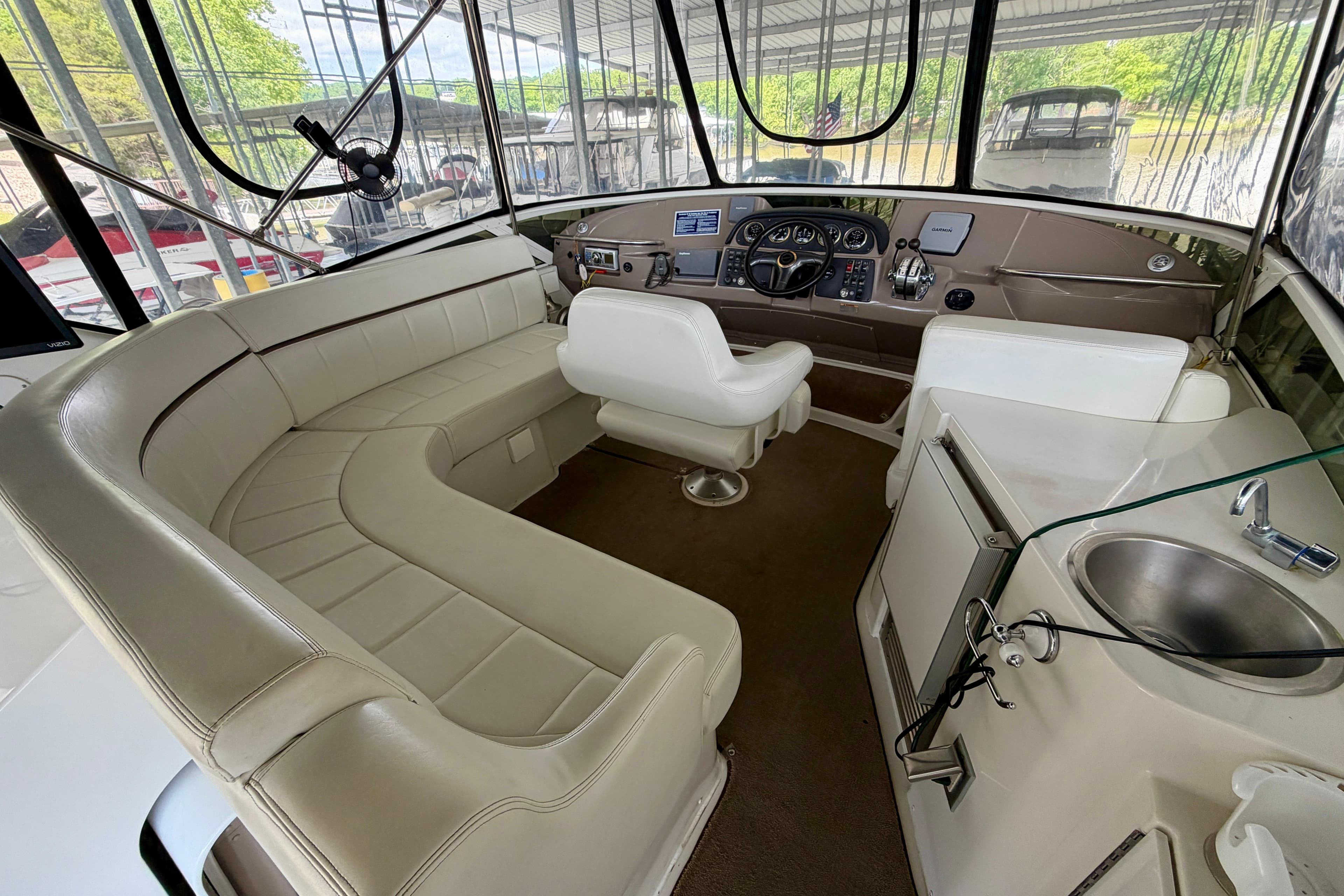 Interior of 2000 Carver 396 Motor Yacht with plush seating and modern helm controls.