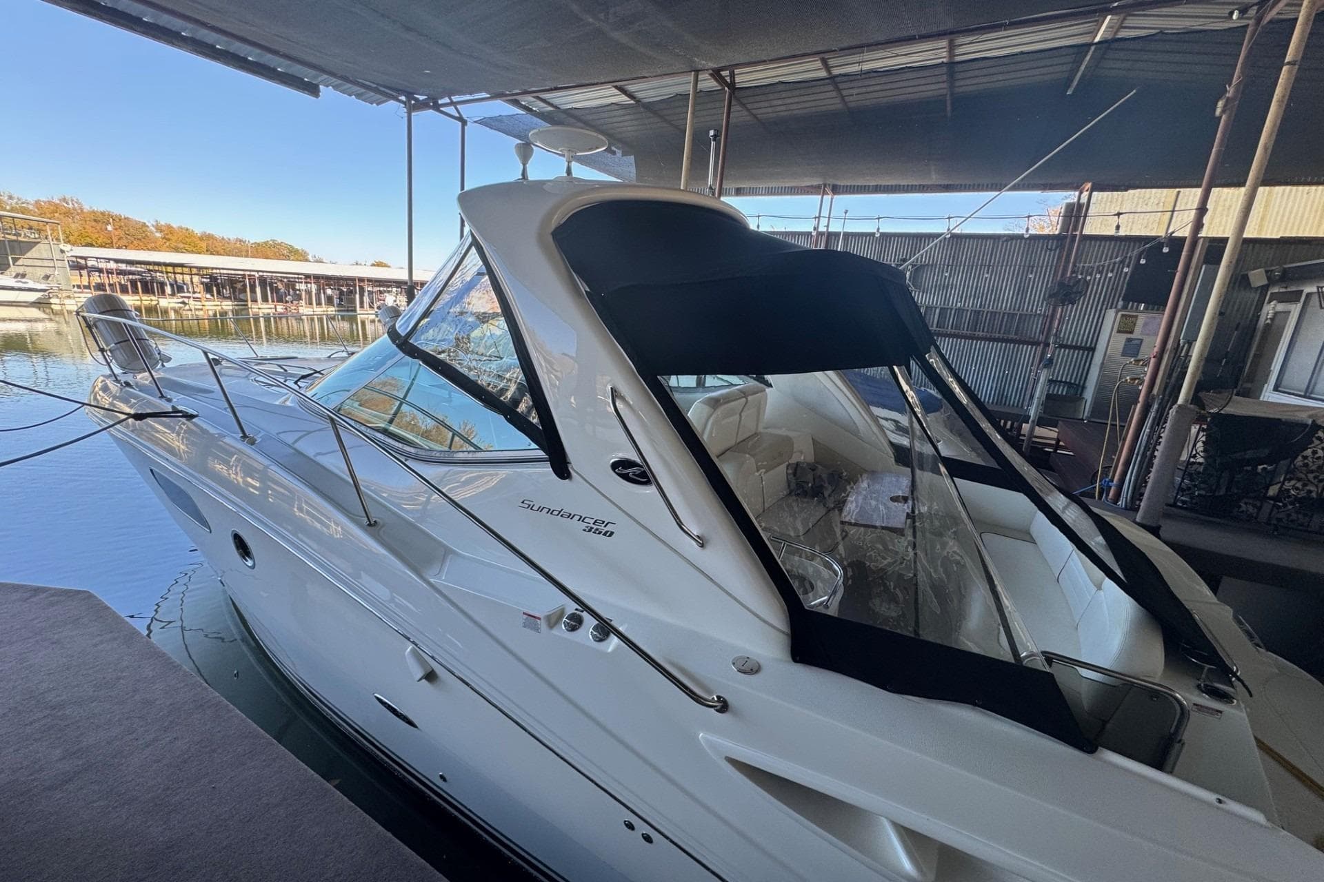 2010 Sea Ray 350 Sundancer docked under a covered marina.