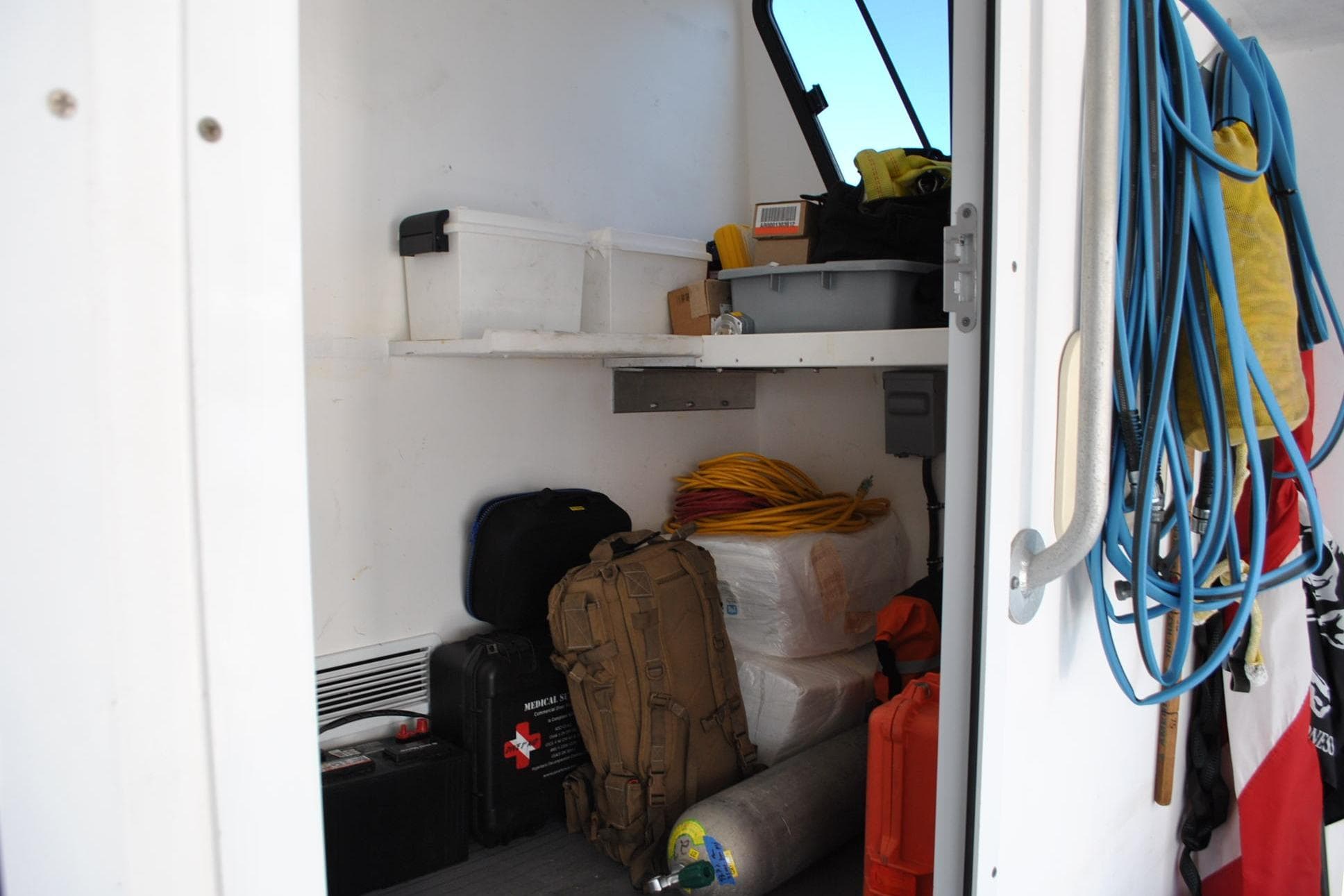Storage area on 2019 Newton 53 dive boat with equipment and supplies.