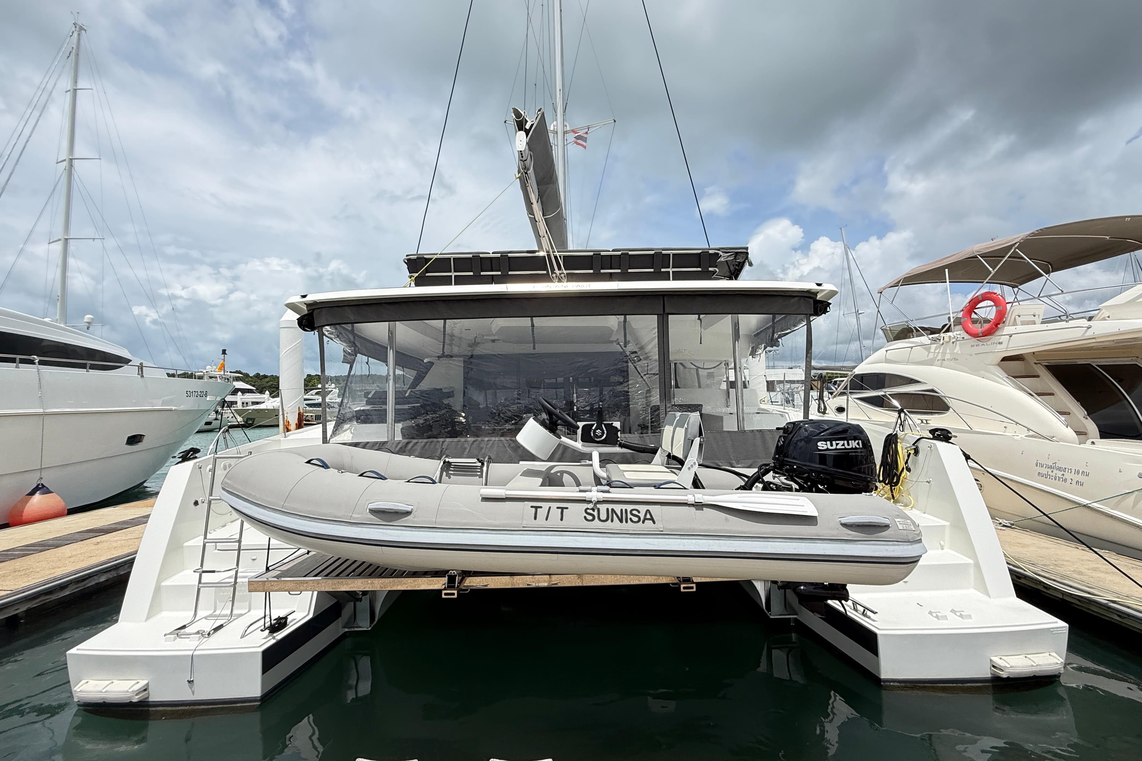 2025 Fountaine Pajot Tanna 47 catamaran docked with inflatable boat.