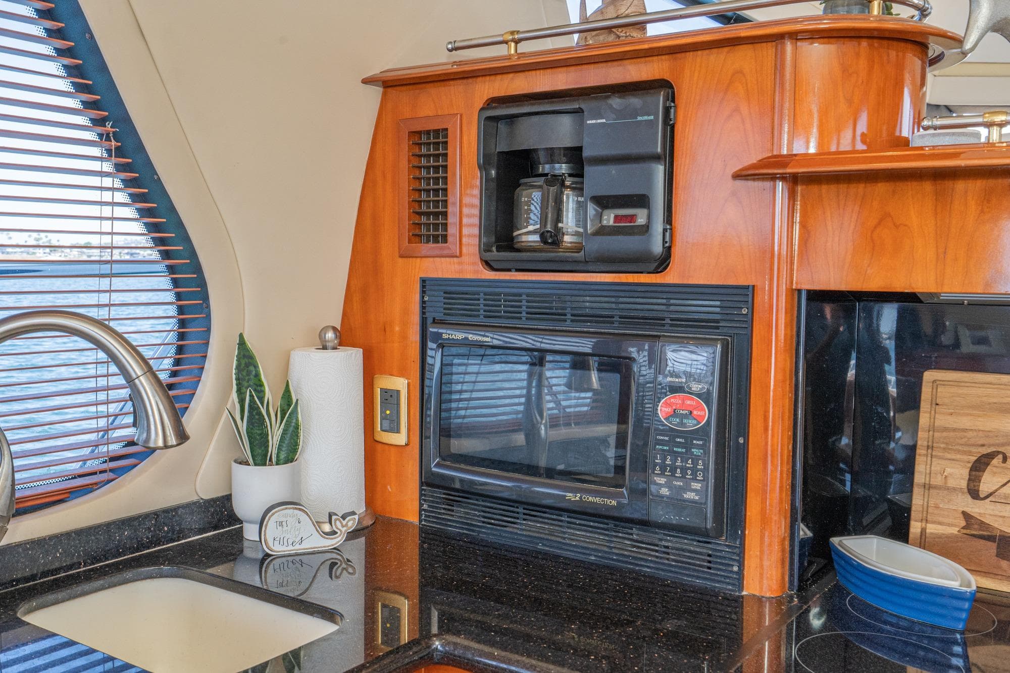 Kitchen area of 2003 Carver 530 Voyager Pilothouse with coffee maker and microwave.