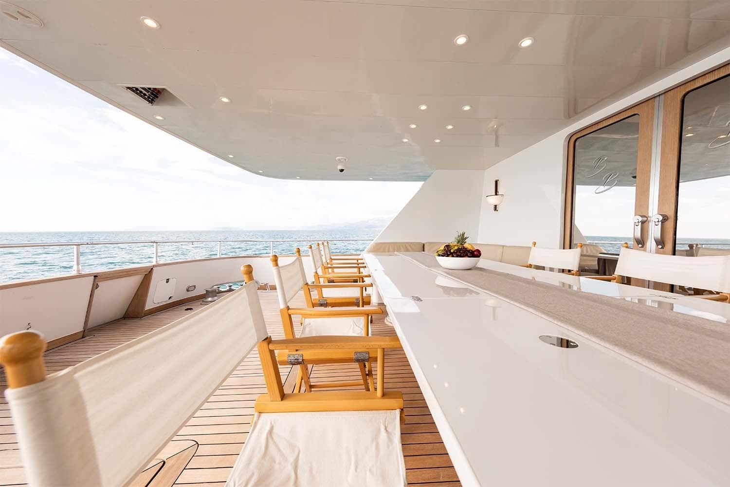 Luxurious deck of 1992 Admiral 28 yacht with elegant dining area and ocean view.
