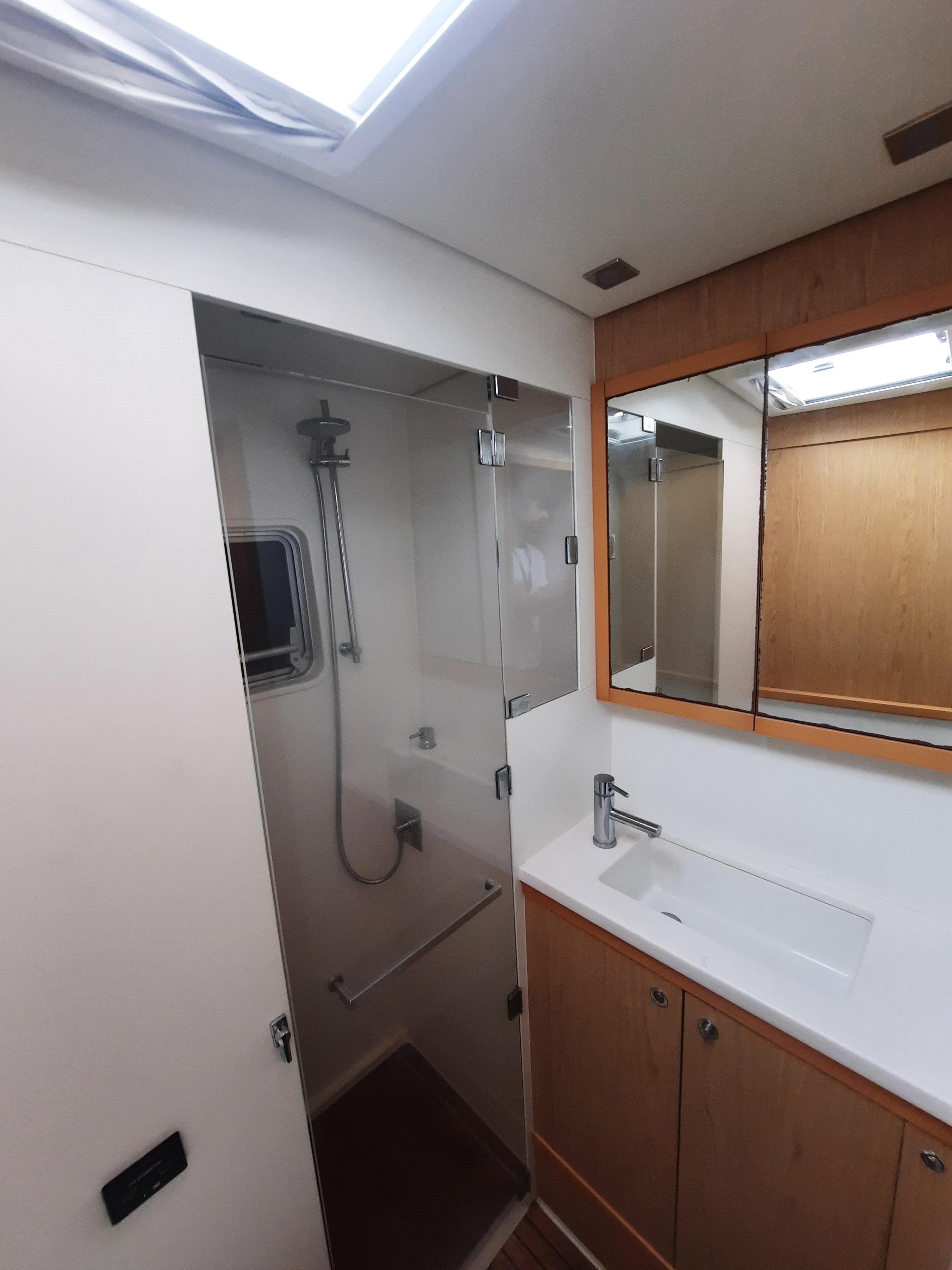 Modern bathroom interior of 2013 Lagoon 52 F yacht with shower and sink.