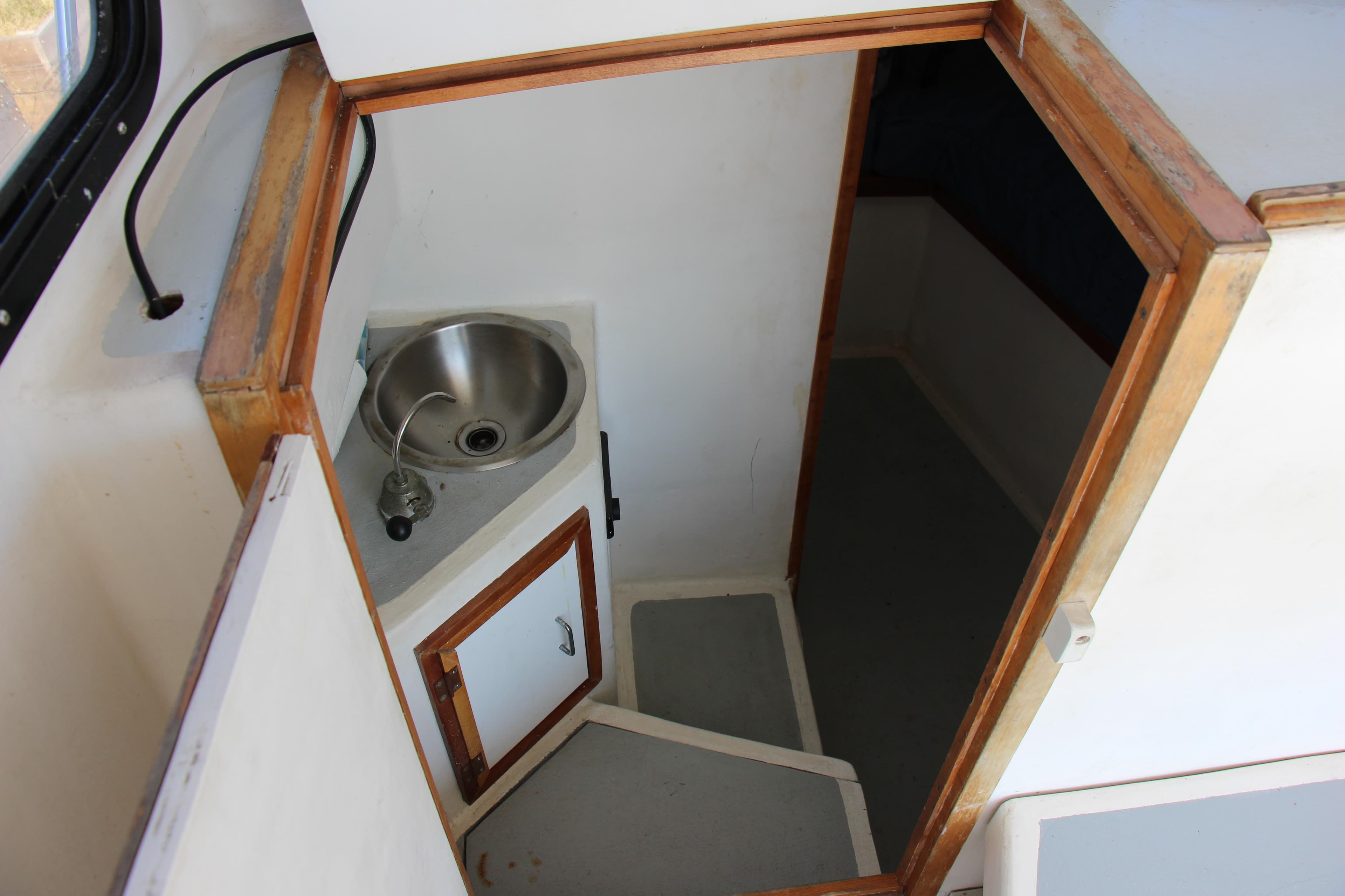 Interior of 2009 Custom Alley Boats 28 Downeast with sink and storage.