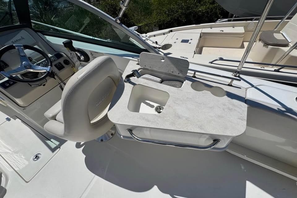 2015 Boston Whaler 230 Vantage boat interior with helm, seating, and sink area.