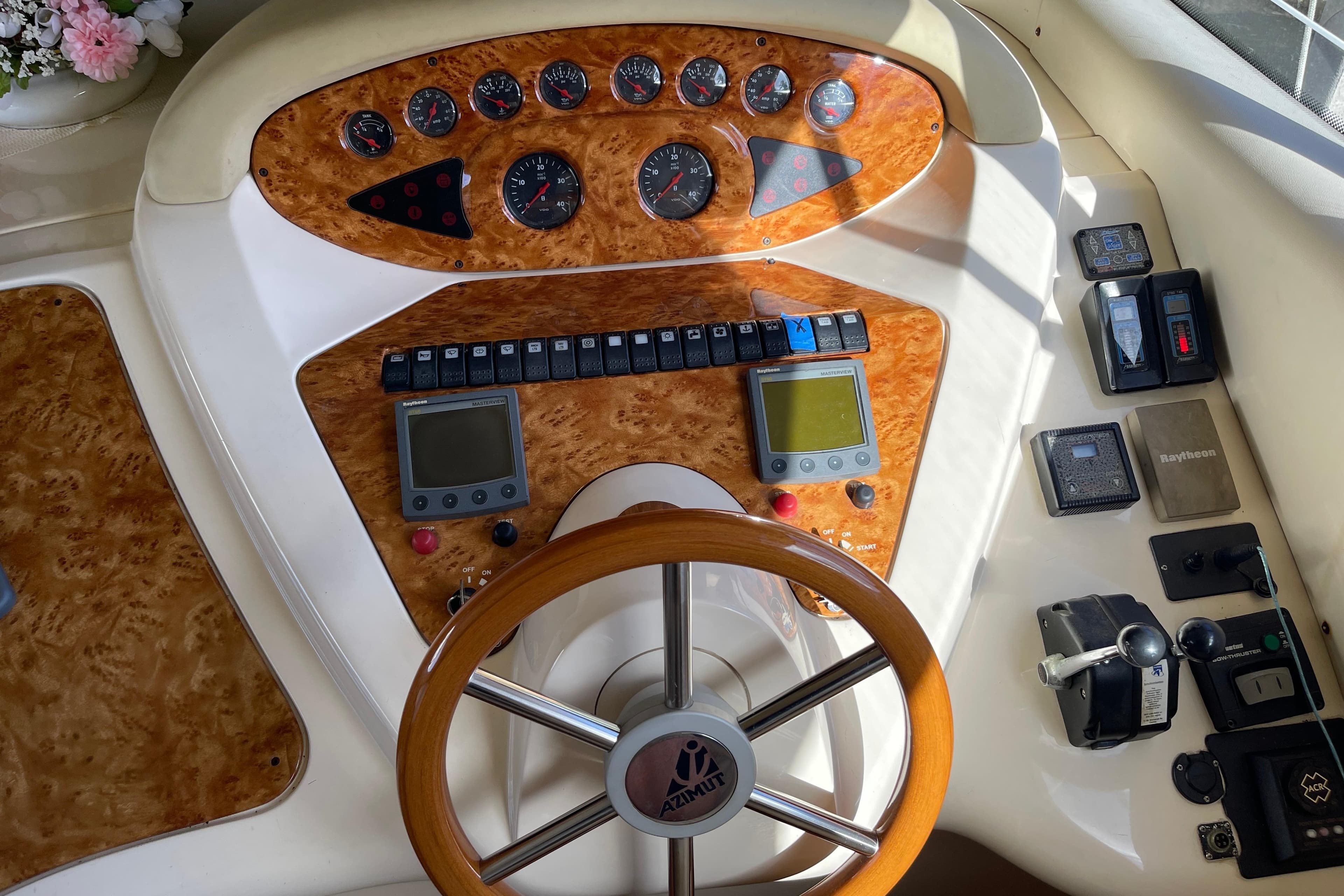 Cockpit of 2000 Azimut 46 Flybridge MY with wood accents and navigation instruments.