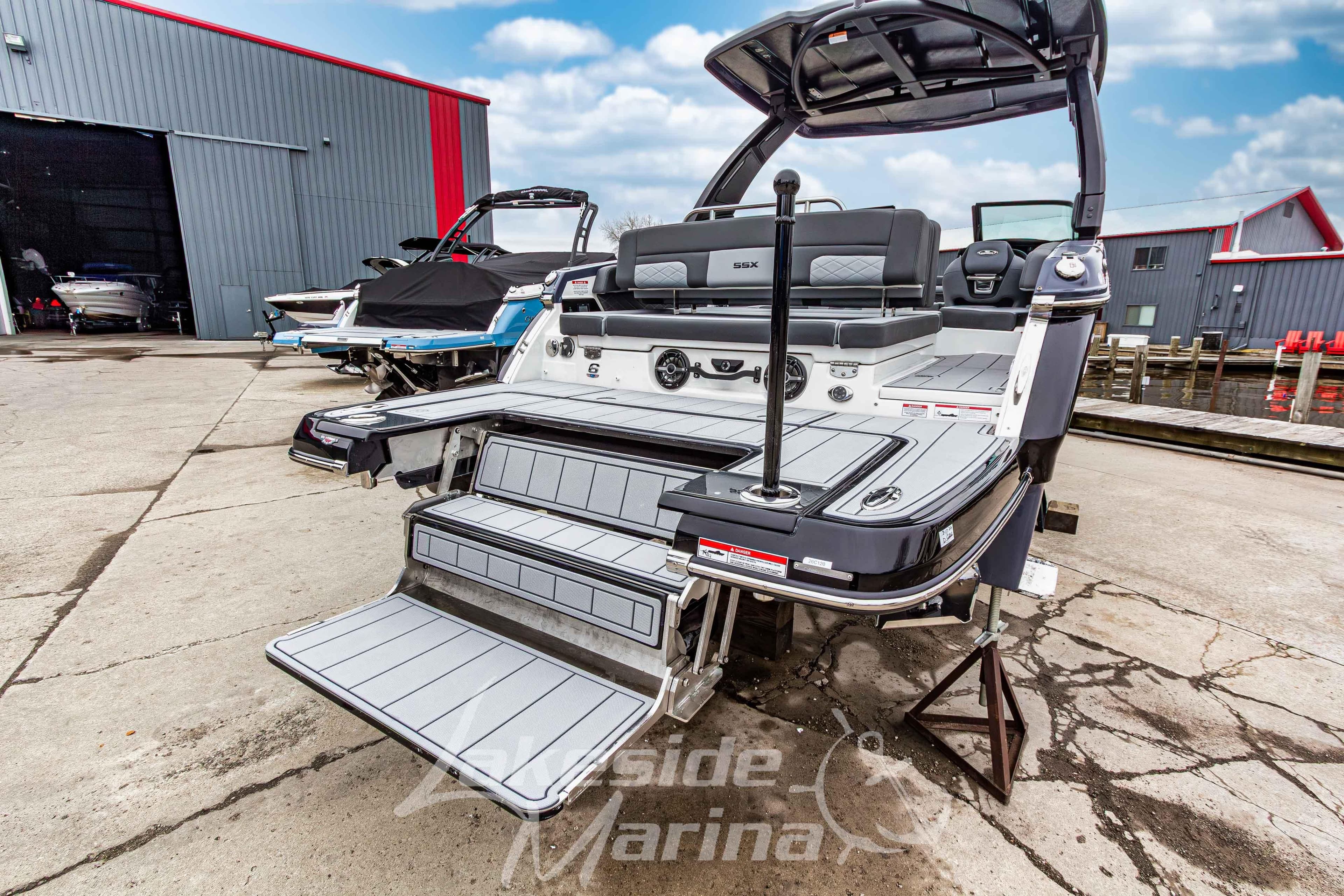 2026 Chaparral SSX 6 boat with swim platform and steps at a marina.