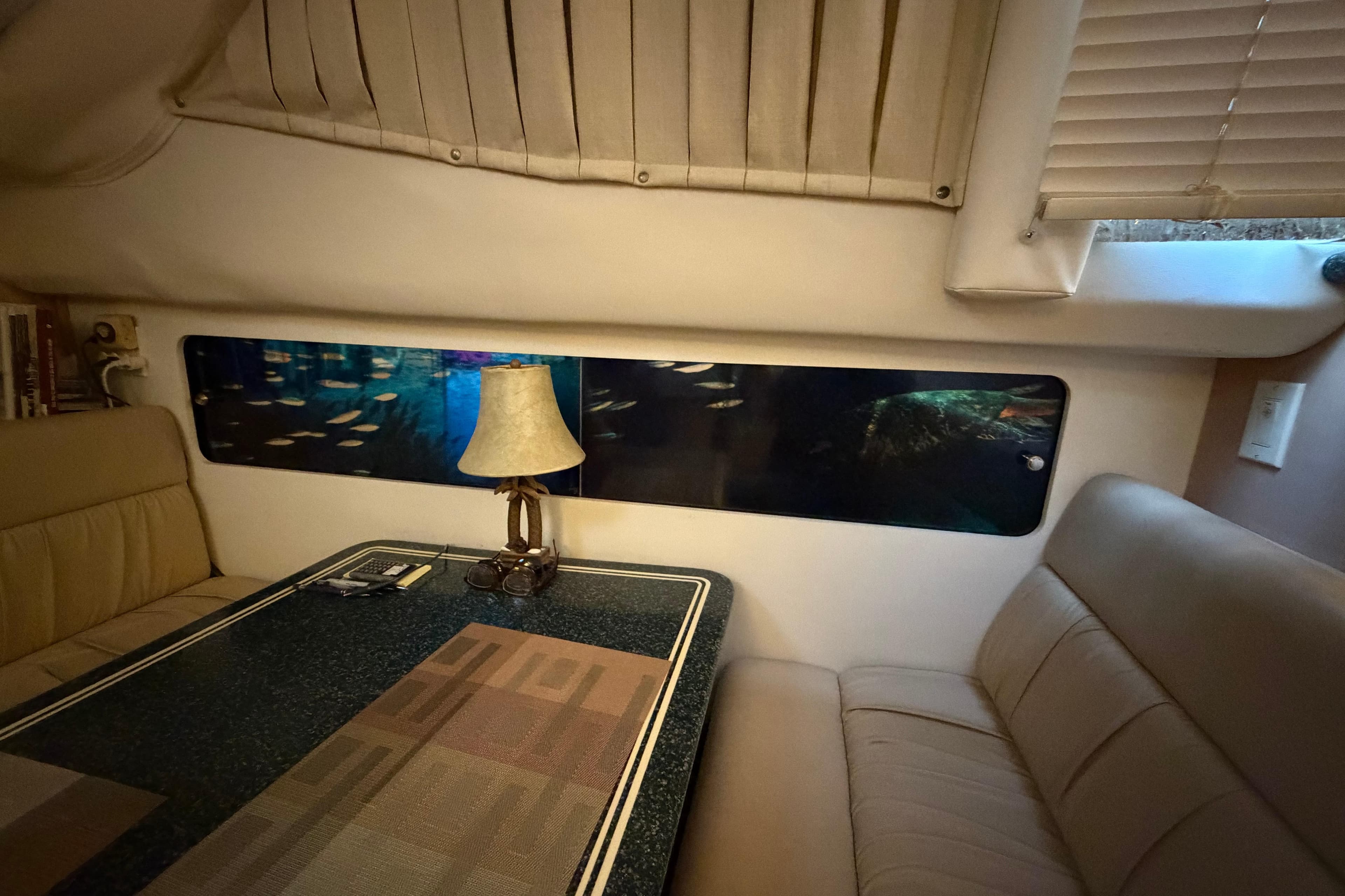 Interior of 2000 Carver 356 Aft Cabin Motor Yacht with cozy seating and lamp.