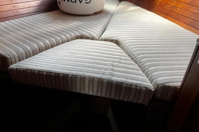 Striped cushions on a CAL 39 MK II Sloop, 1980, wooden seating area.