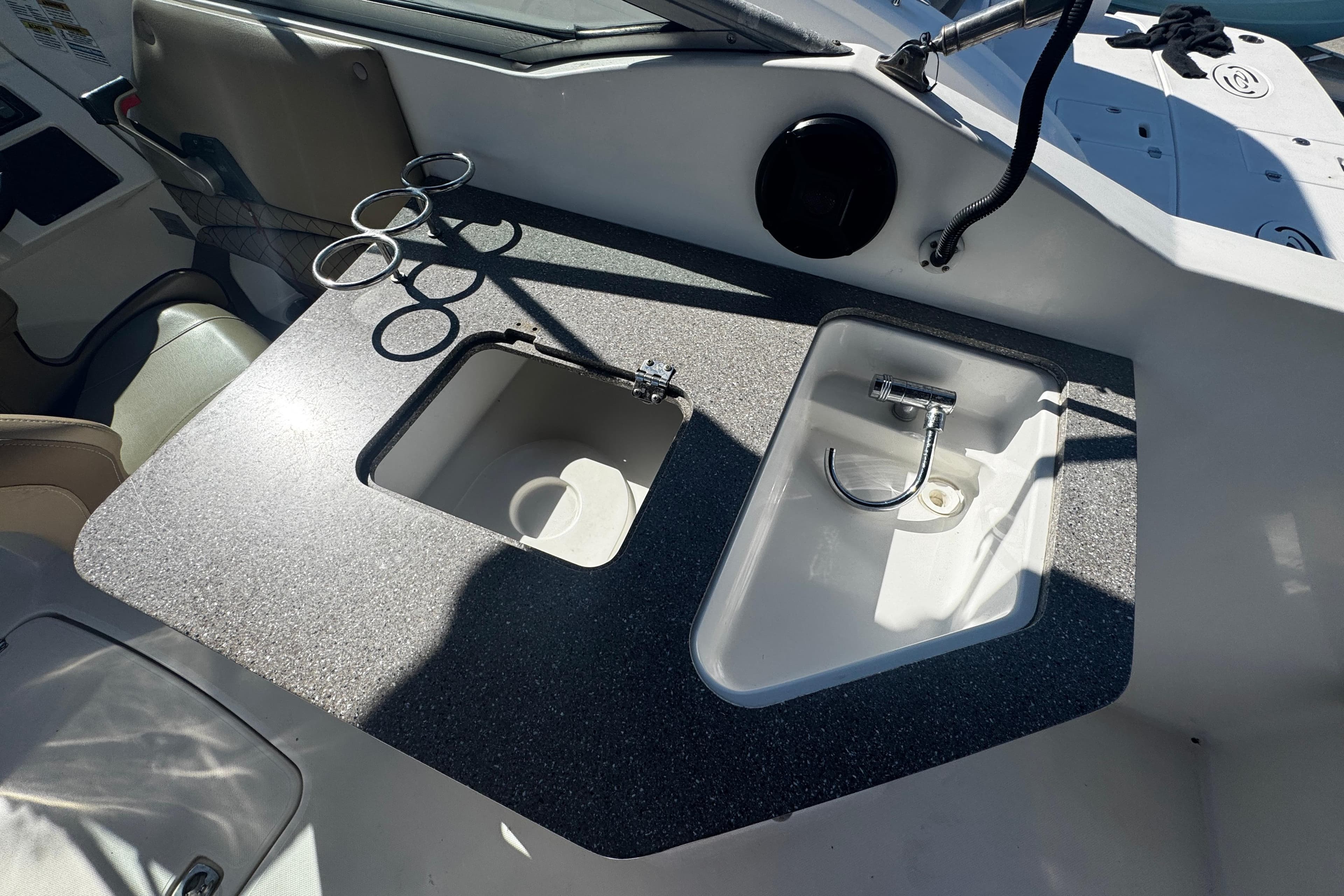 2019 Hurricane SunDeck 2690 OB boat interior with sink and cup holders.