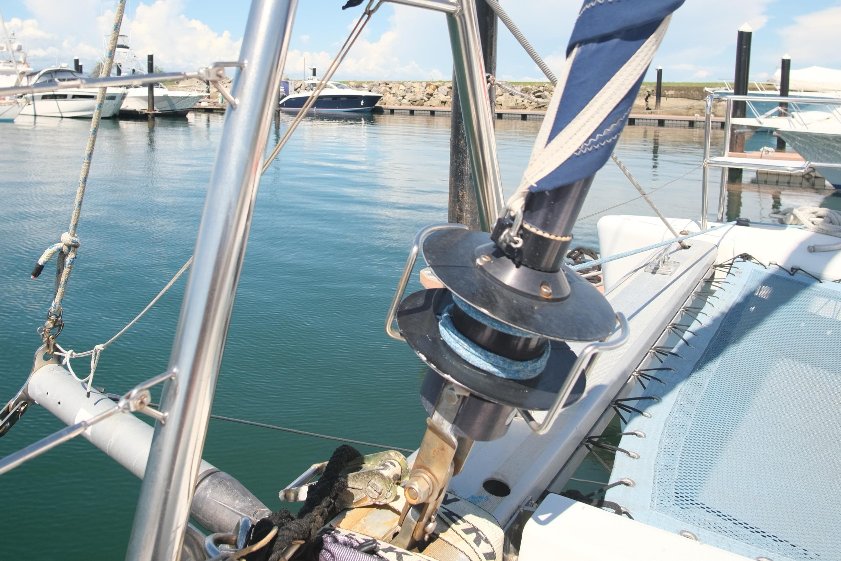 Lagoon 440 catamaran docked, showcasing rigging and trampoline, 2002 model.