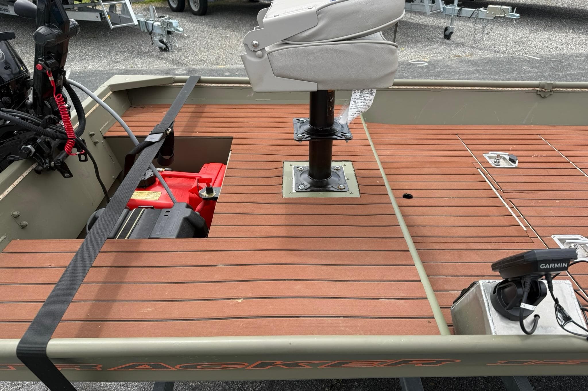 2025 Tracker Grizzly 1542 boat interior with wooden deck and mounted seat.