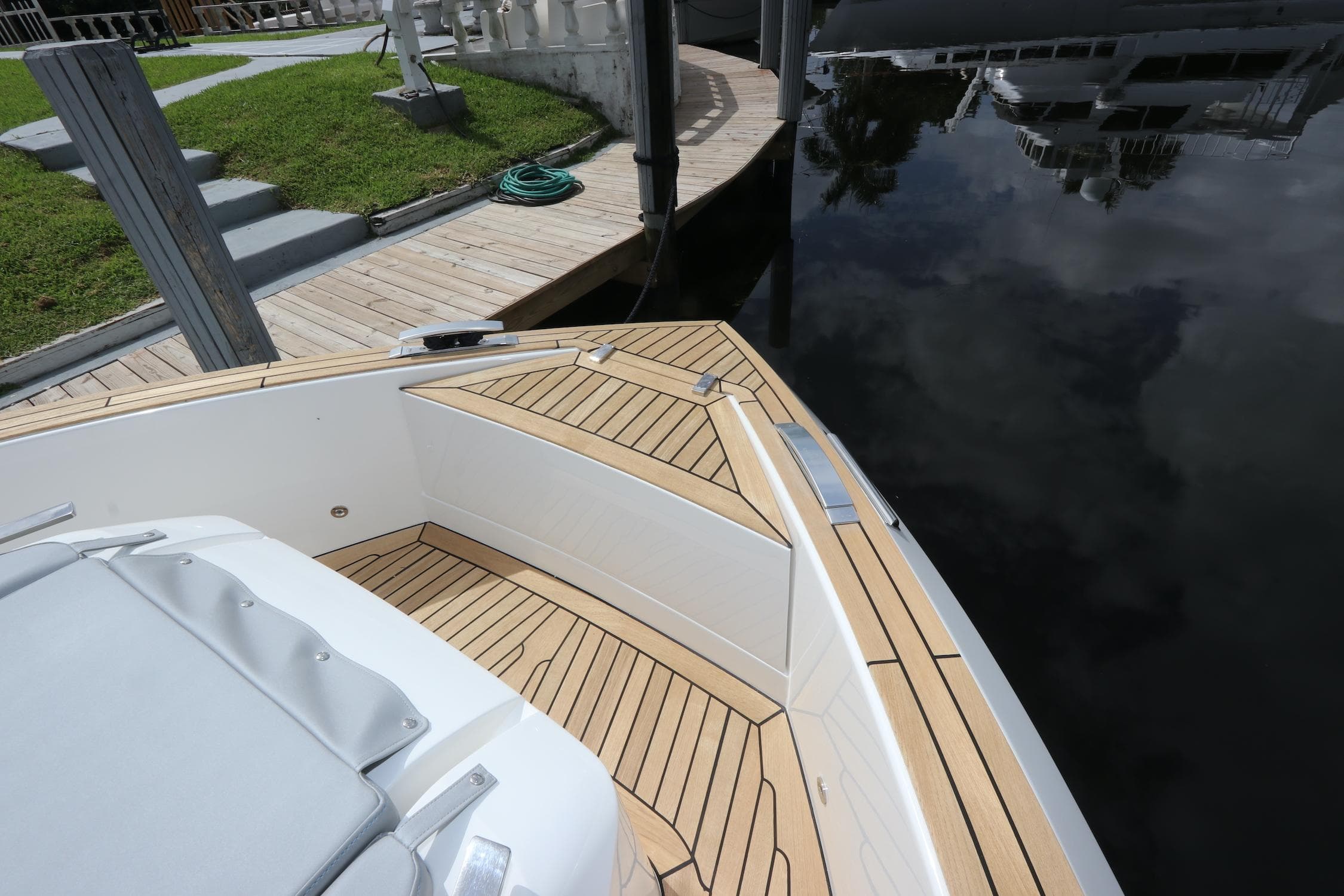 2024 Astondoa 377 Coupe Outboard boat with sleek deck design by the water.