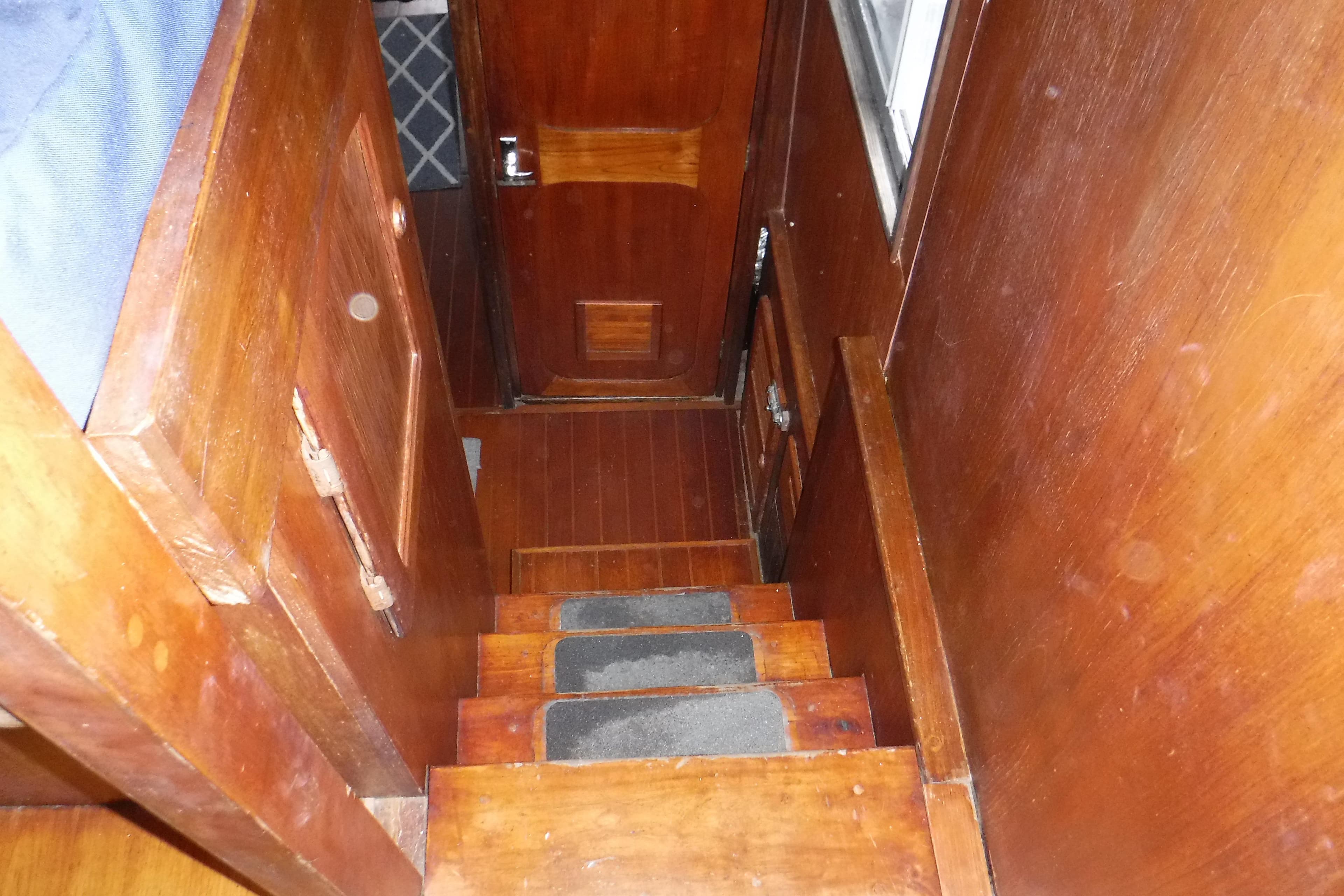 Wooden interior stairs of 1988 Dudley Dix Echo 38 sailboat.