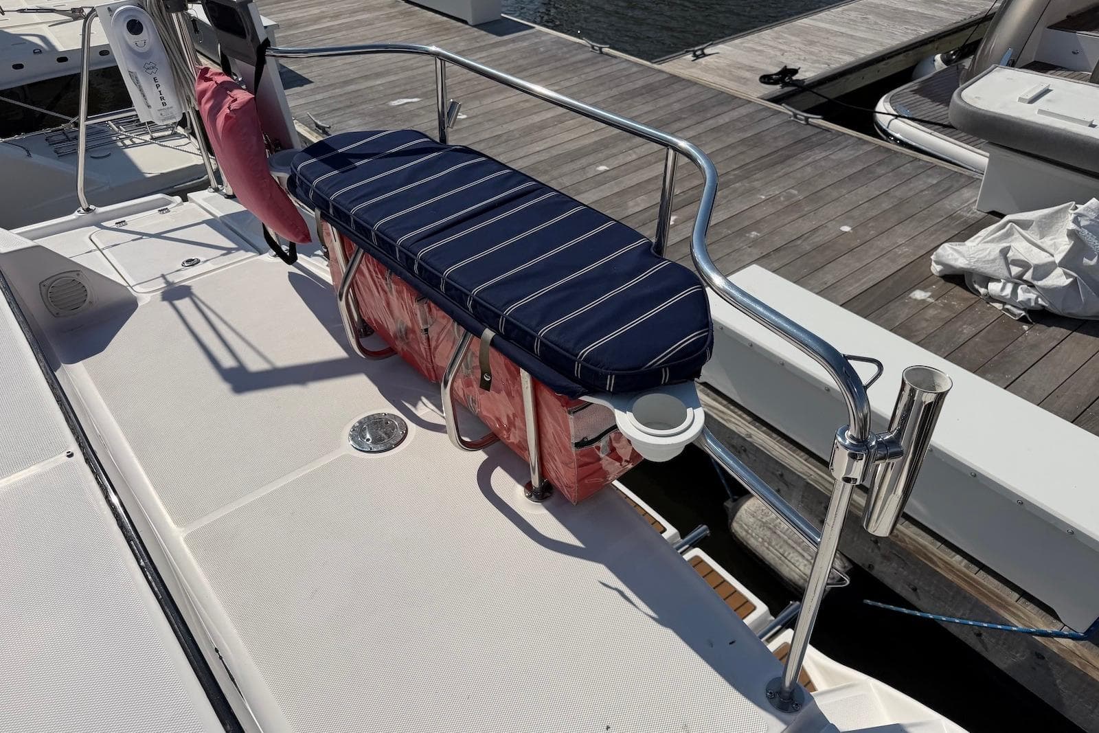 2009 Hunter 50 Center Cockpit boat deck with striped cushion and railing.