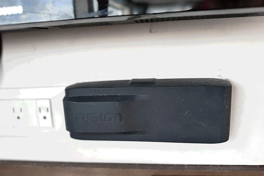 Black device mounted on a wall near electrical outlets, Lagoon 40, 2019 model.