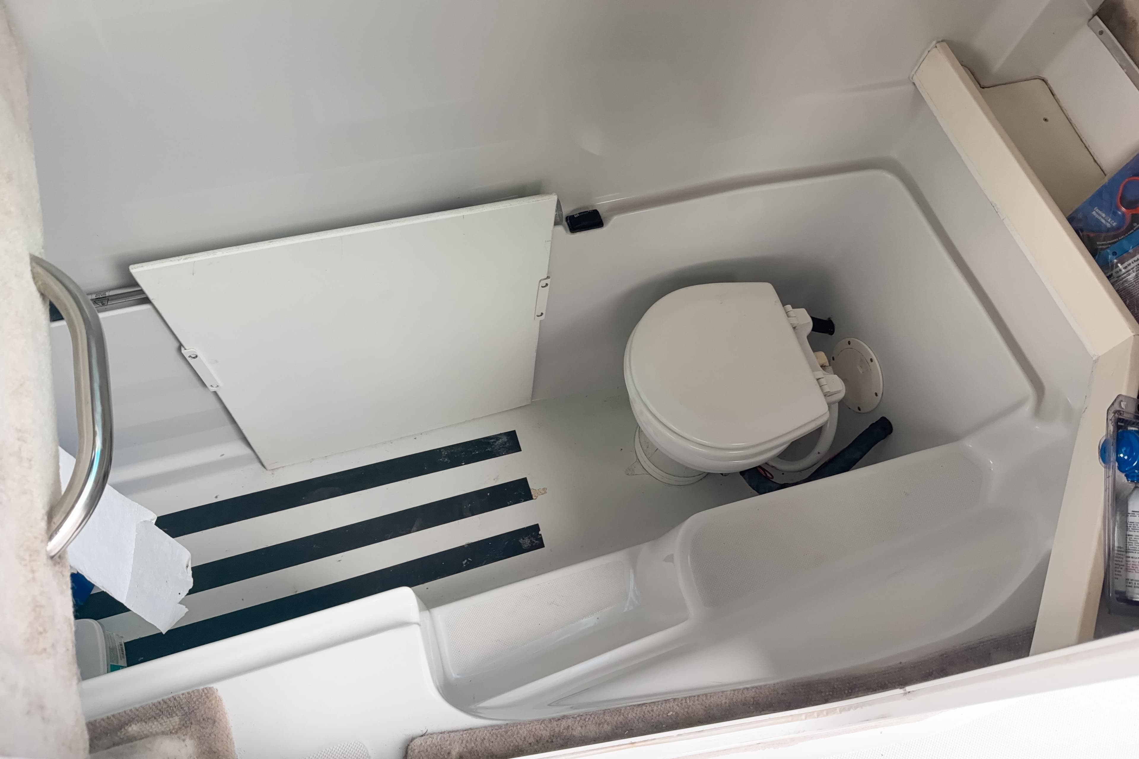 2007 Glacier Bay 2640SX Renegade boat interior with compact marine toilet.