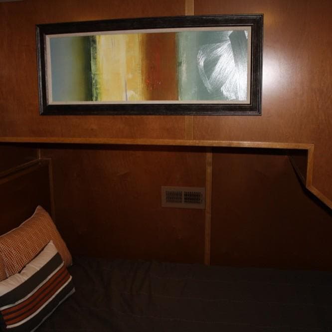 Interior of 2015 Bravada Intrepid Share #10 with abstract wall art and wooden paneling.