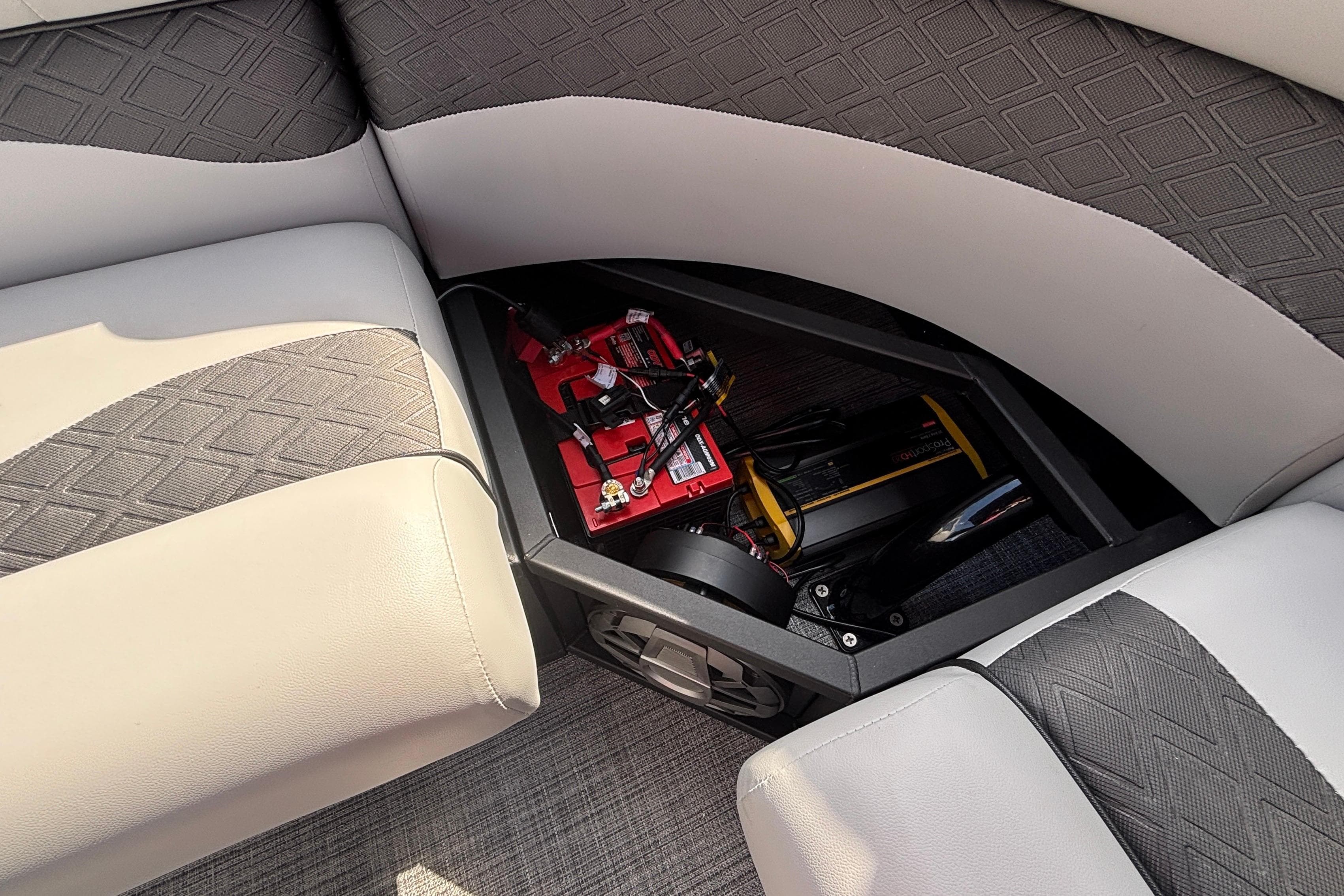 Interior of 2026 JC NEPTOON 27TT SPORT boat showing storage compartment with battery.