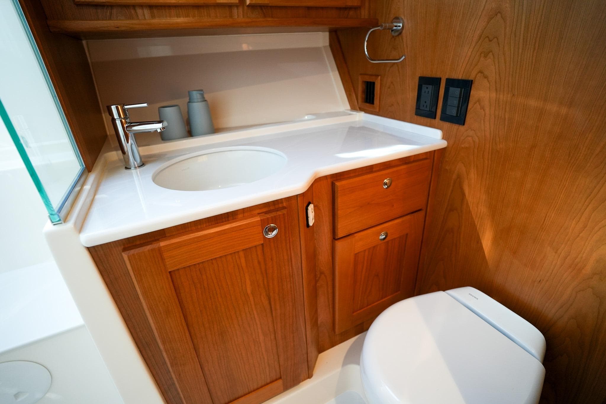Luxurious bathroom in 2026 Sabre 51 Salon Express yacht with wooden cabinetry.