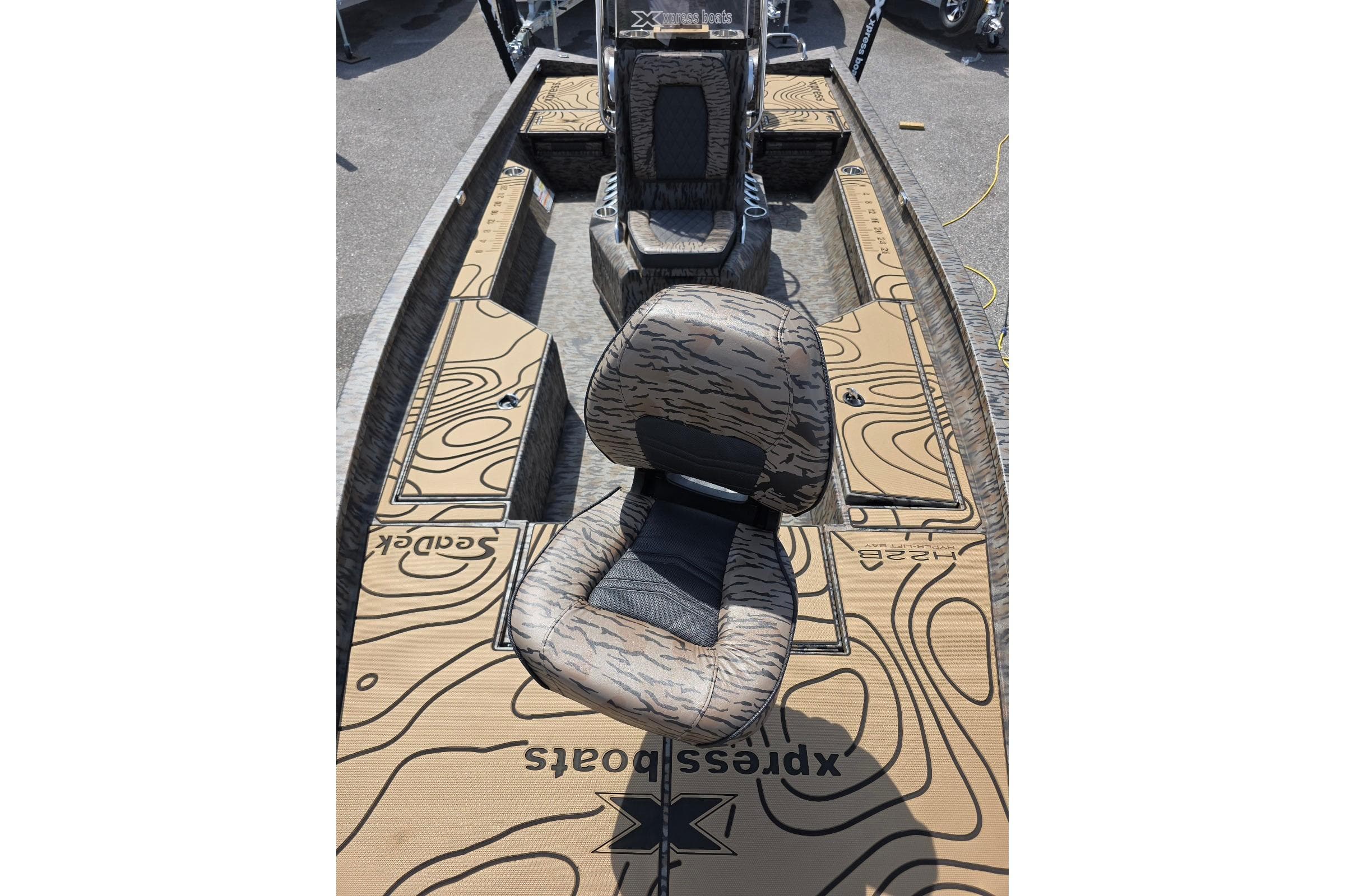2026 Xpress H22B Bay boat interior with patterned seating and deck design.